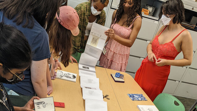 Students look at an artists book