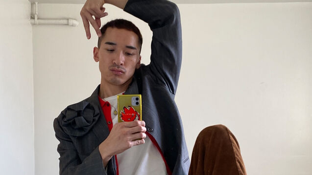 A designer poses for a mirror selfie
