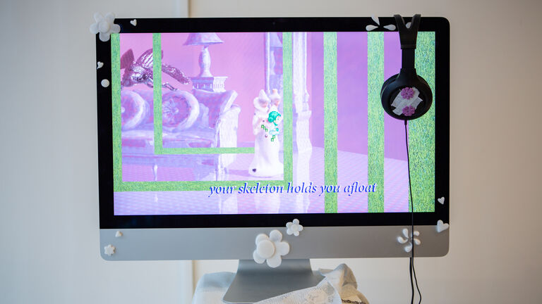 A monitor with a video game amination of a figure. 