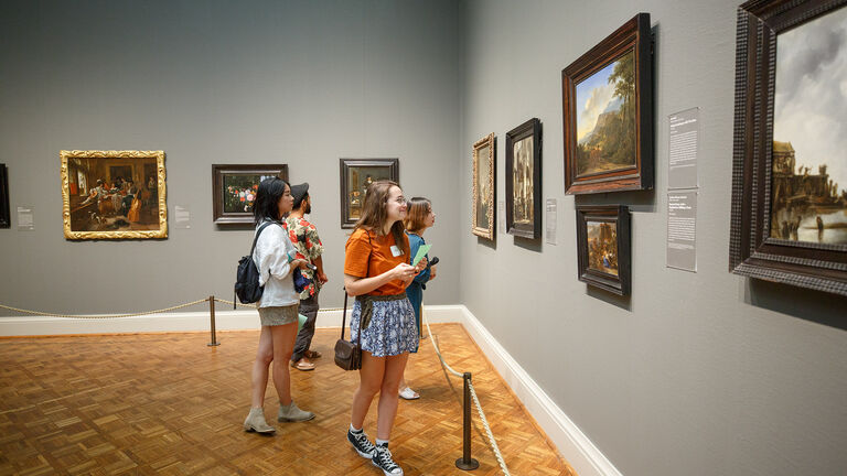 A small group of students looking at art in The Art Institute of Chicago museum. 