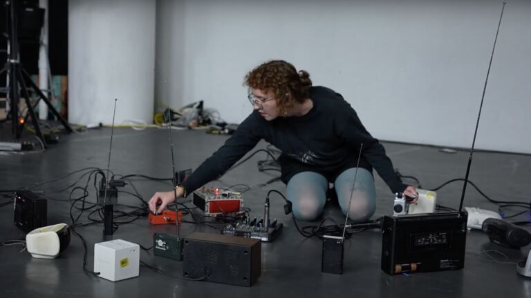 An image of an SAIC sound student working with sound equipment