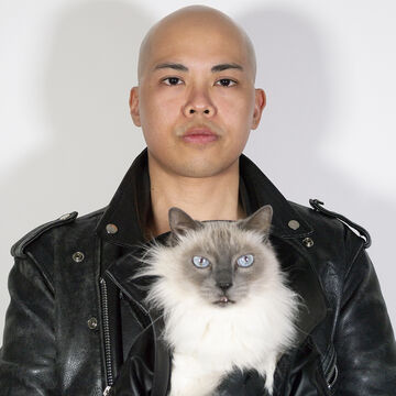 A portrait of a person holding a cat 
