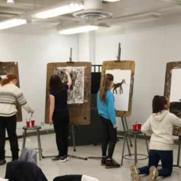 Continuing Studies students stand in studio and draw at easels