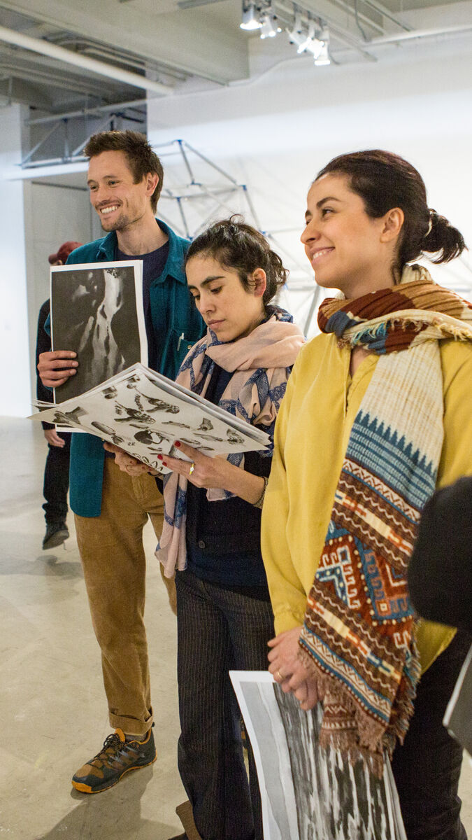 A group of students discussing art in a gallery. 