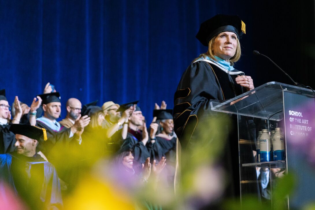 President Elissa Tenny stands at the Commencement podium