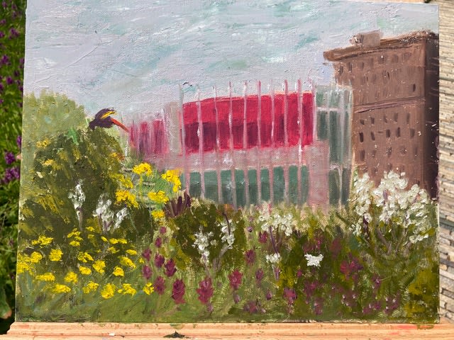 A watercolor of a building and flowers