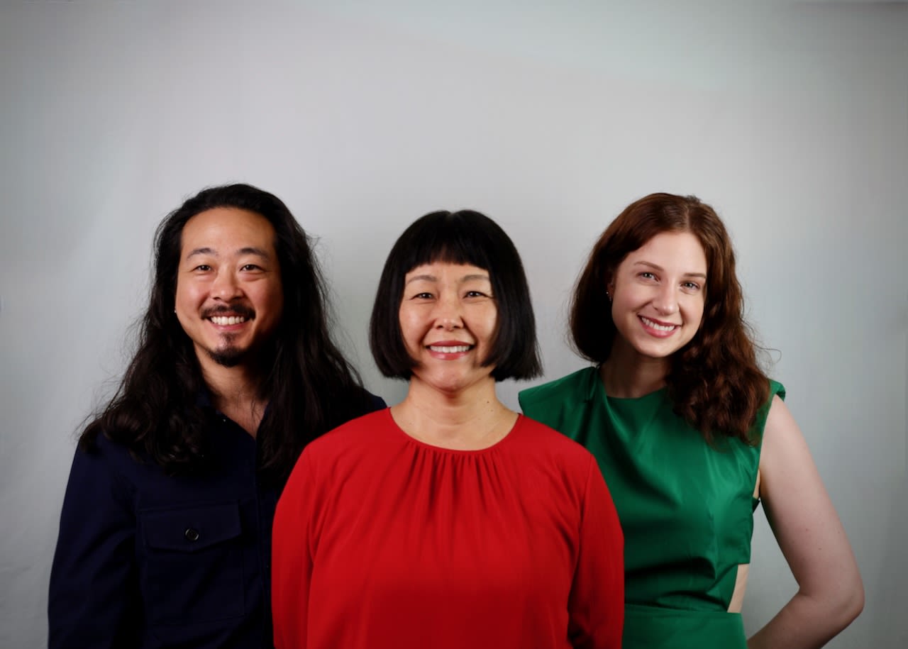 Three family members stand for a portrait