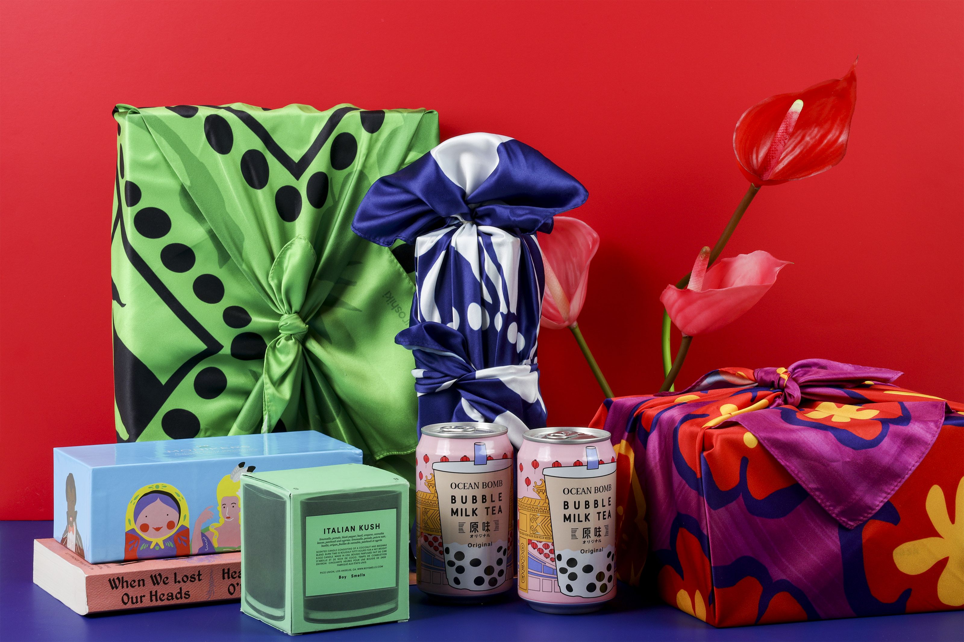 A collection of boxes wrapped in brightly color fabric 