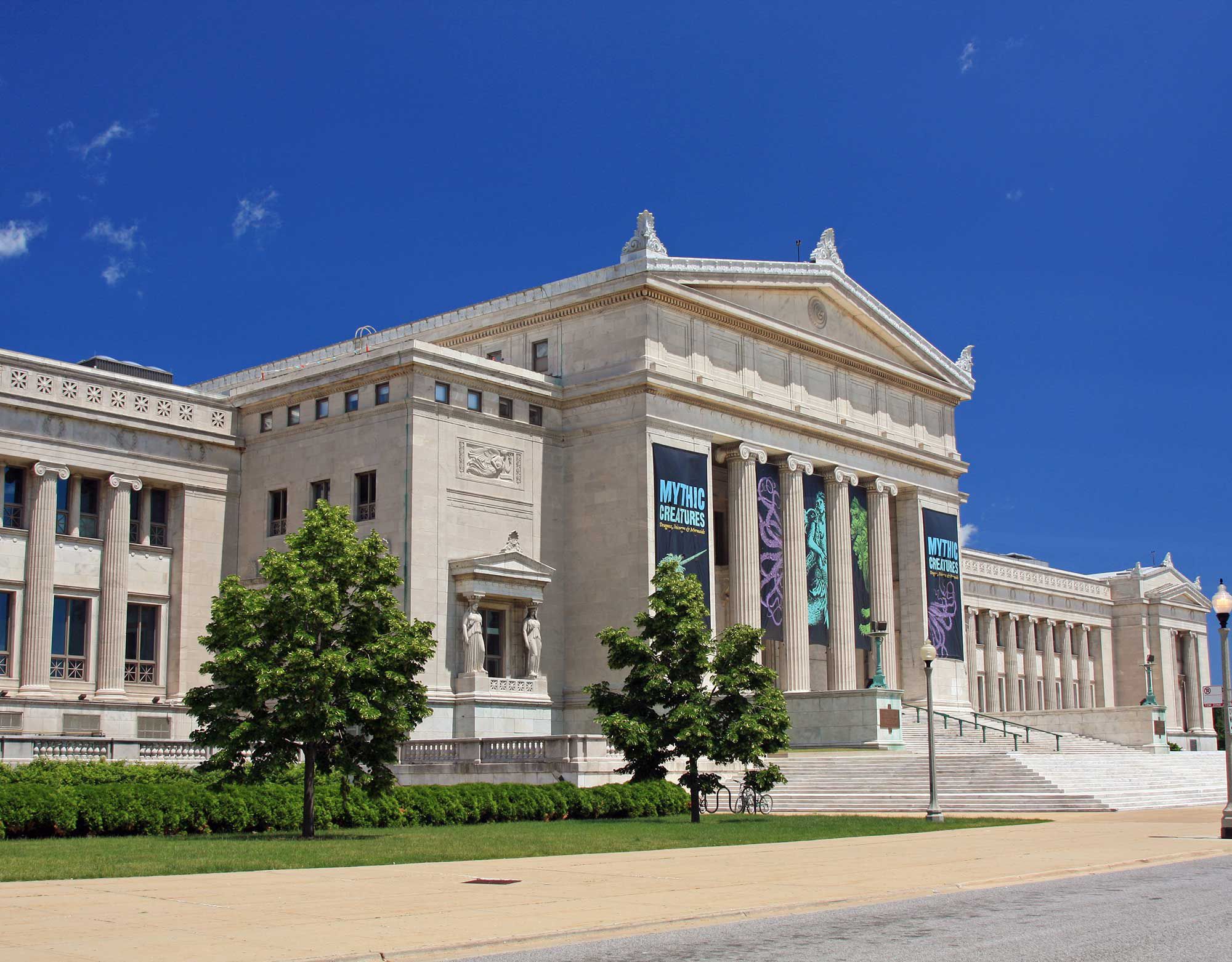 The exterior of a classic museum with columns and carvings