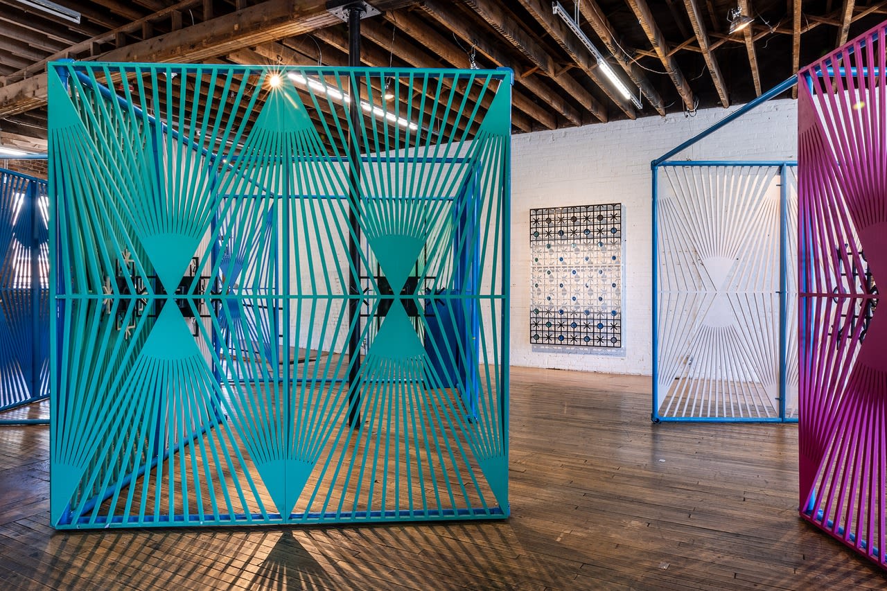 Large, colorful metal sculptures in a gallery space