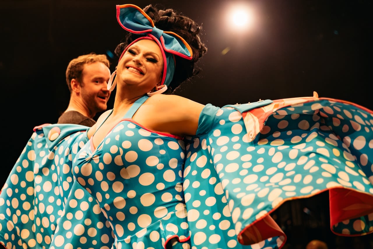 BenDeLaCrem posing in a bright blue outfit with white polka dots