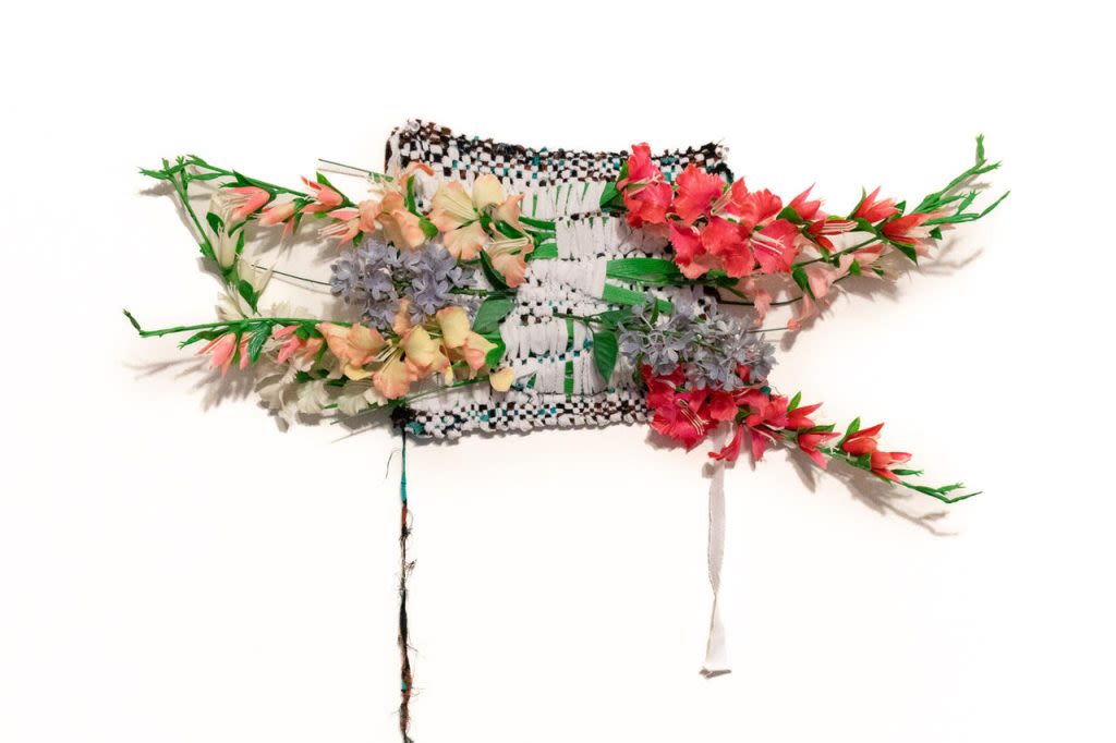 A woven piece with a profusion of flowers