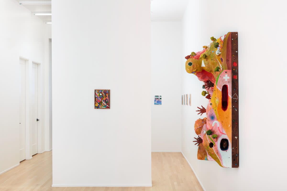 A museum space with bright and sculptural paintings on the walls
