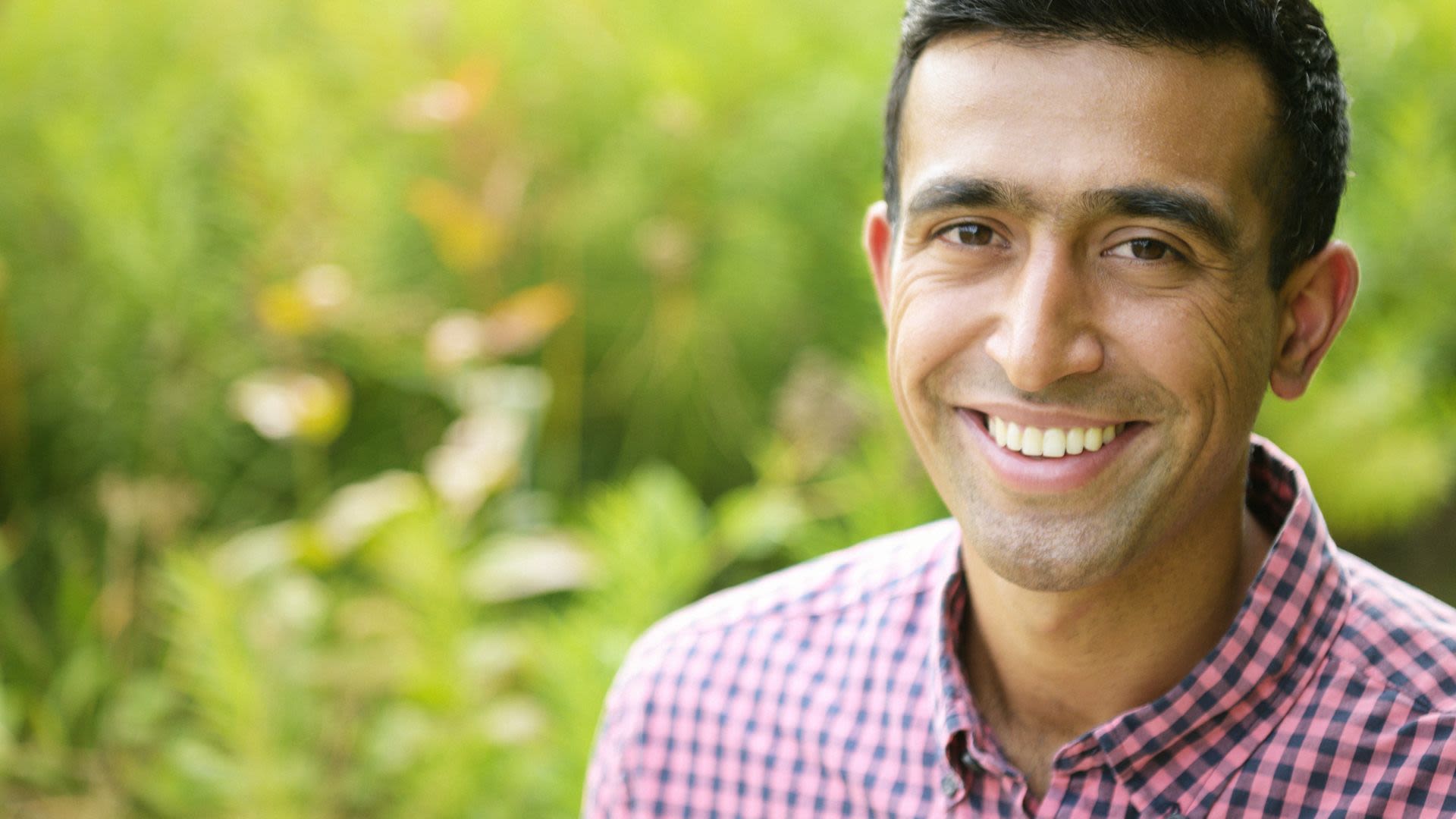Raghav Rao smiling in a field