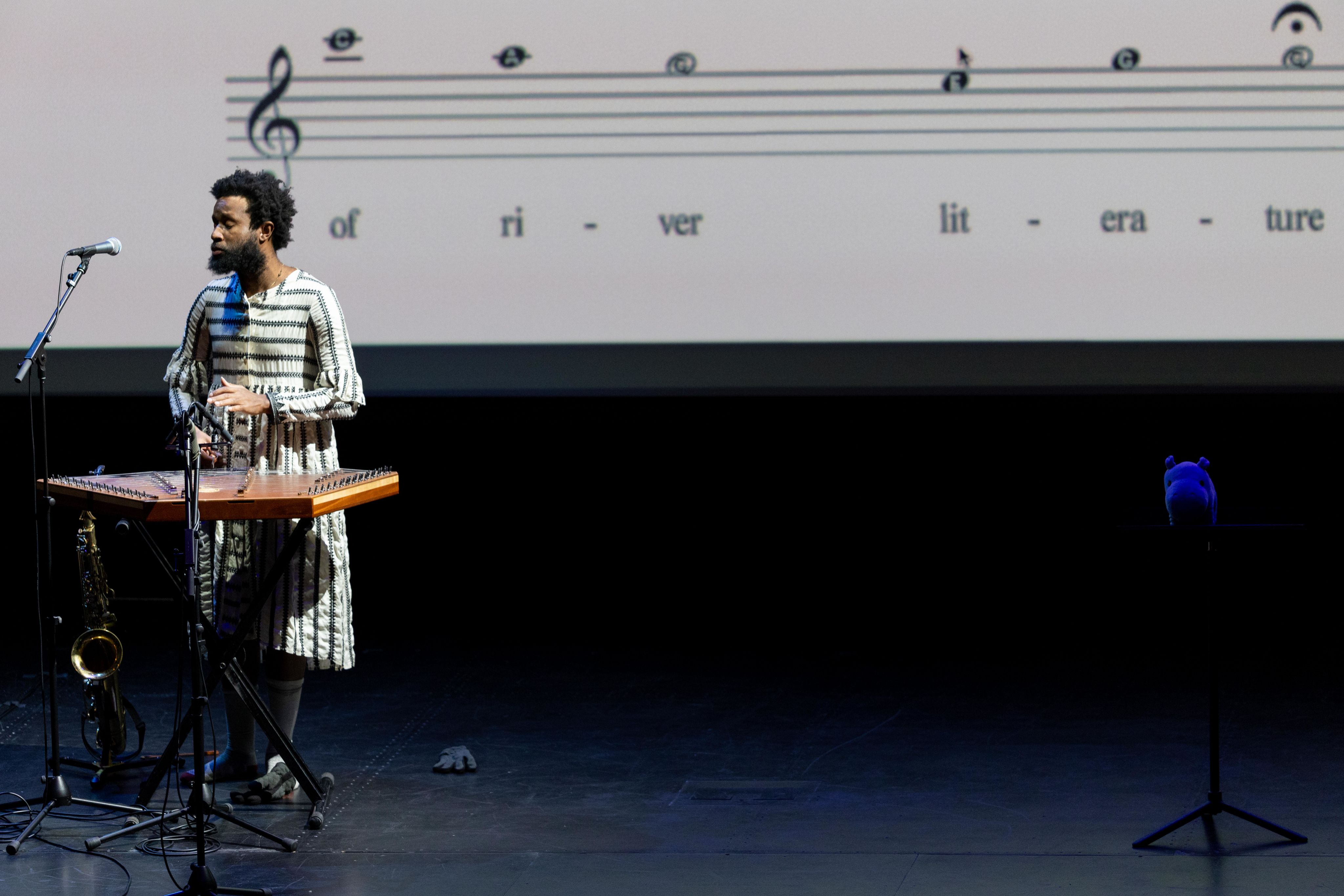 JJJJJerome standing in front of projected music bars