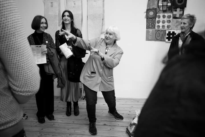 Marianna Buchwald gesturing in a crowded space