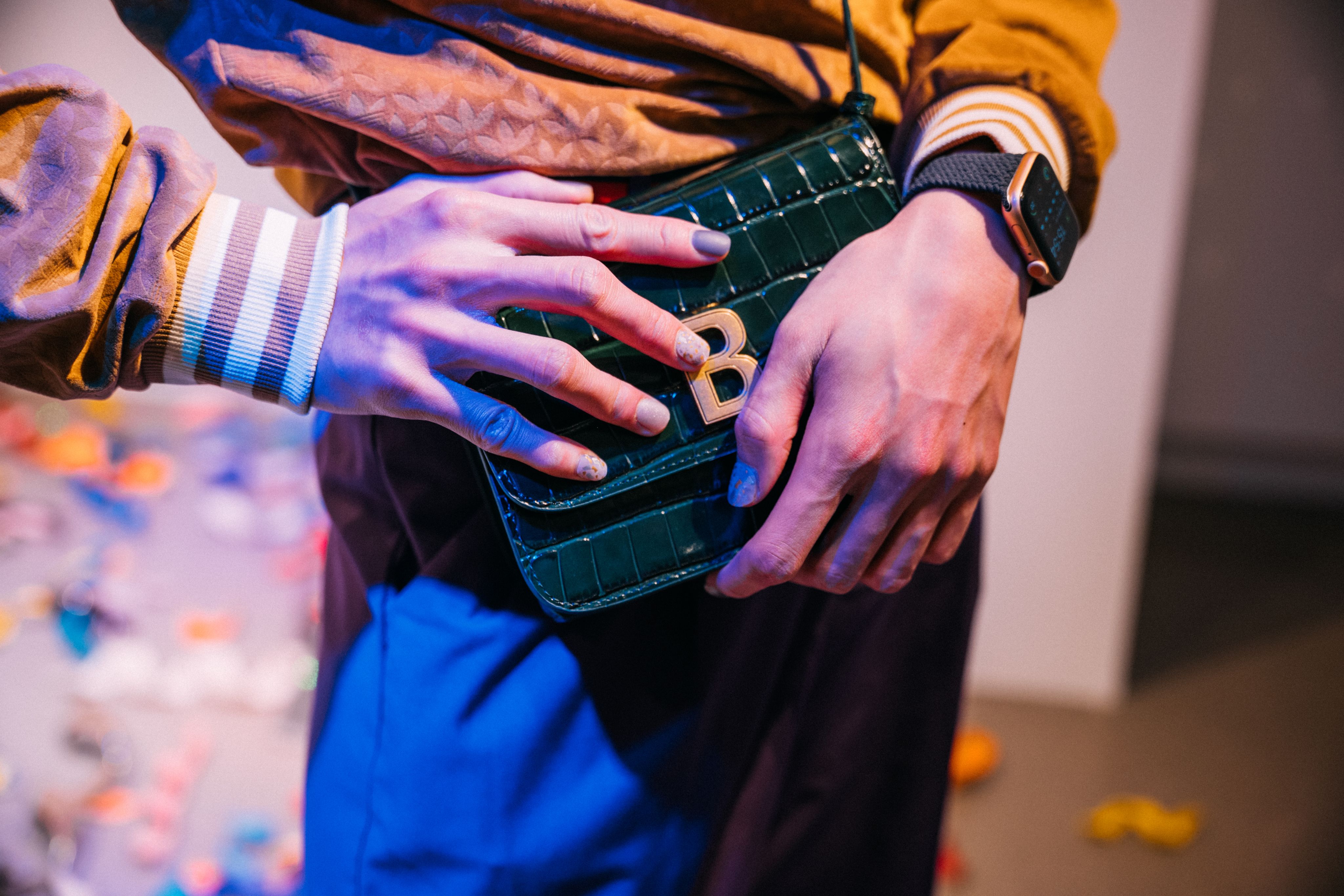 A close-up shot of a leather bag with a metal letter B. 