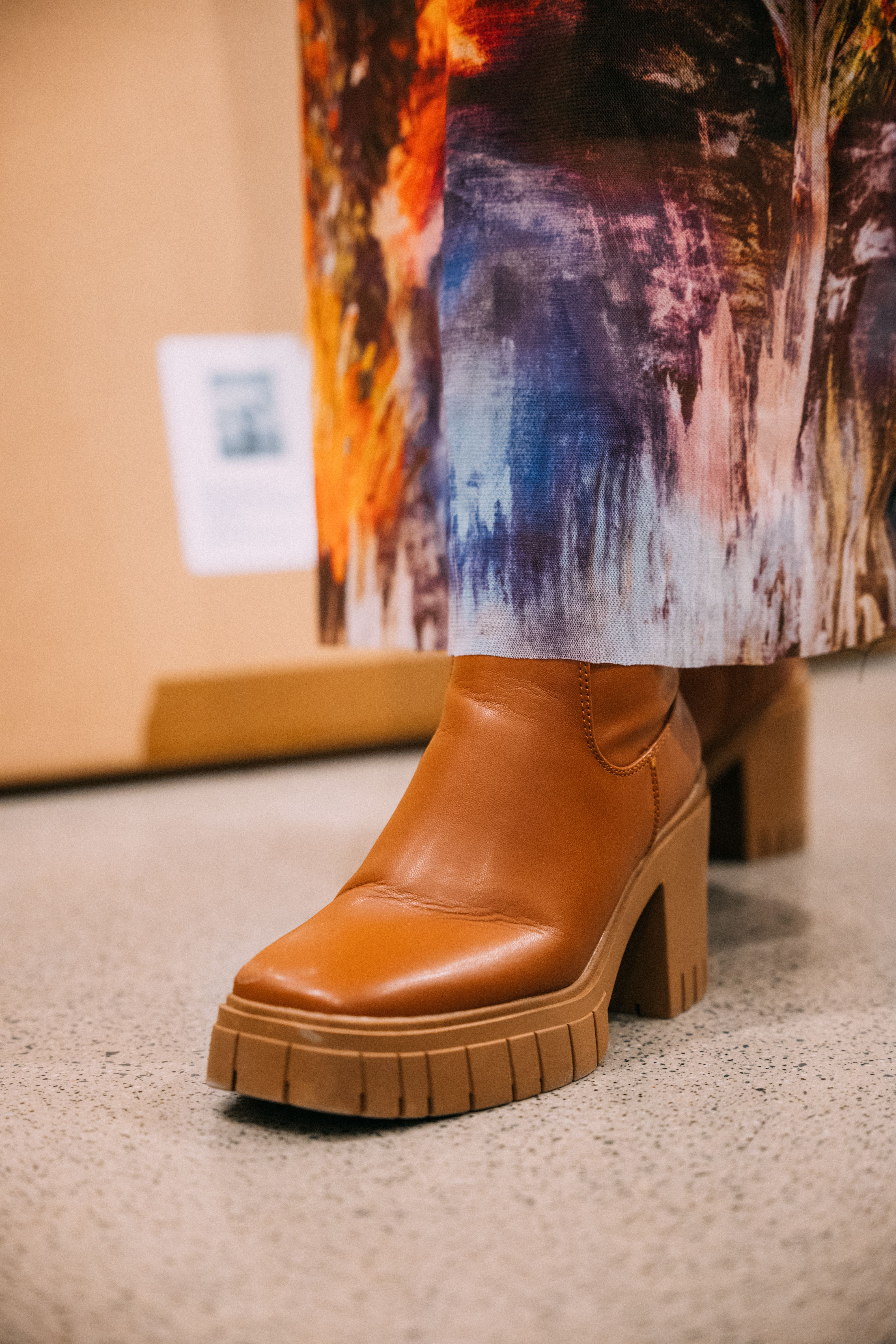 A close-up shot of a student's brown leather boots