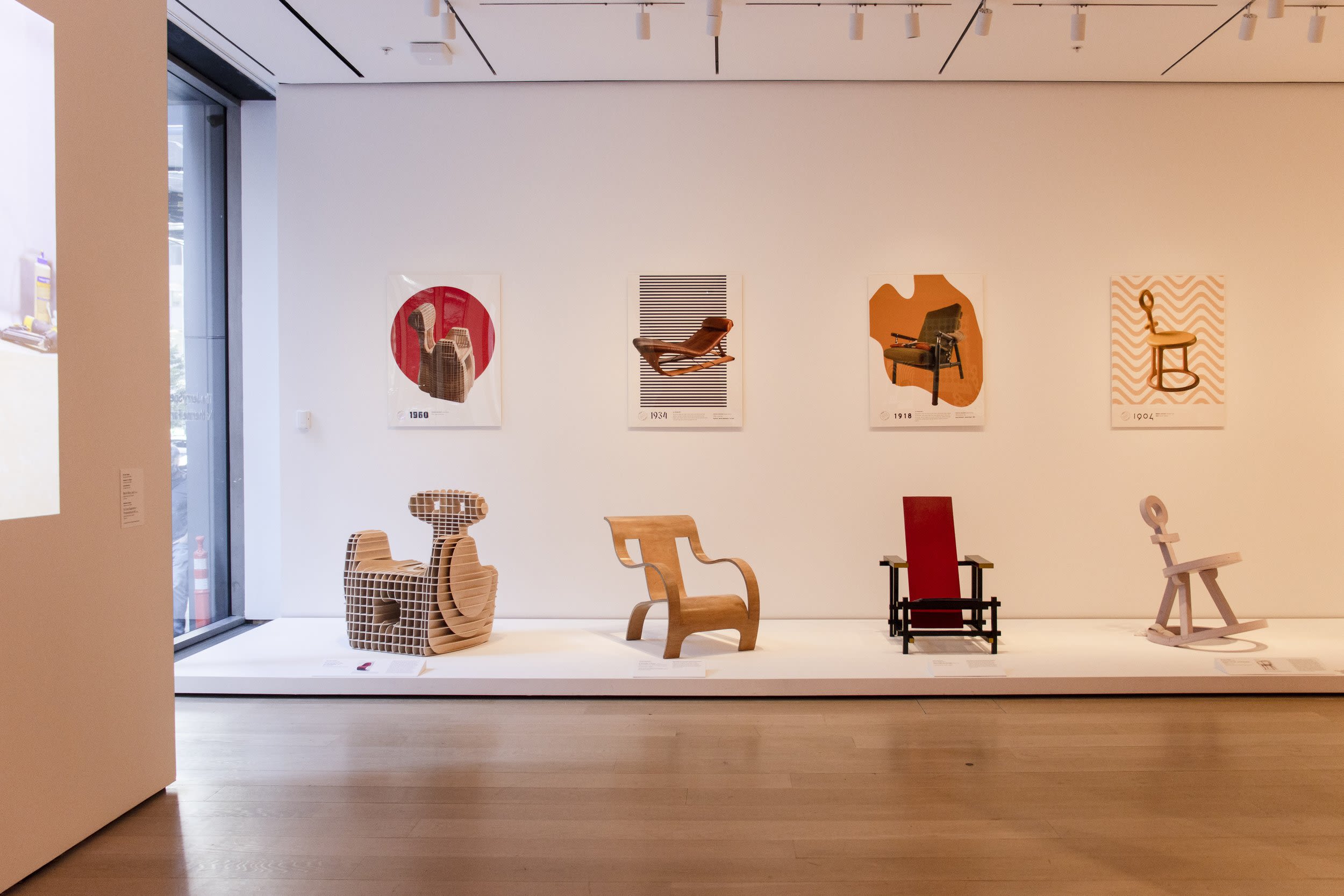 A line of chairs and posters on view at MoMA