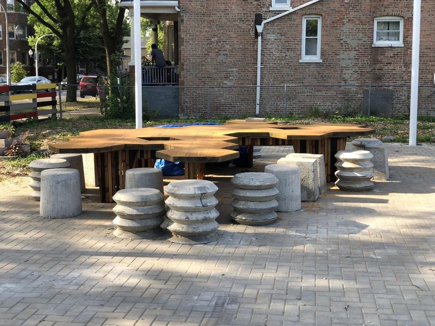 Honeycomb-shaped tables and concrete stools in a garden