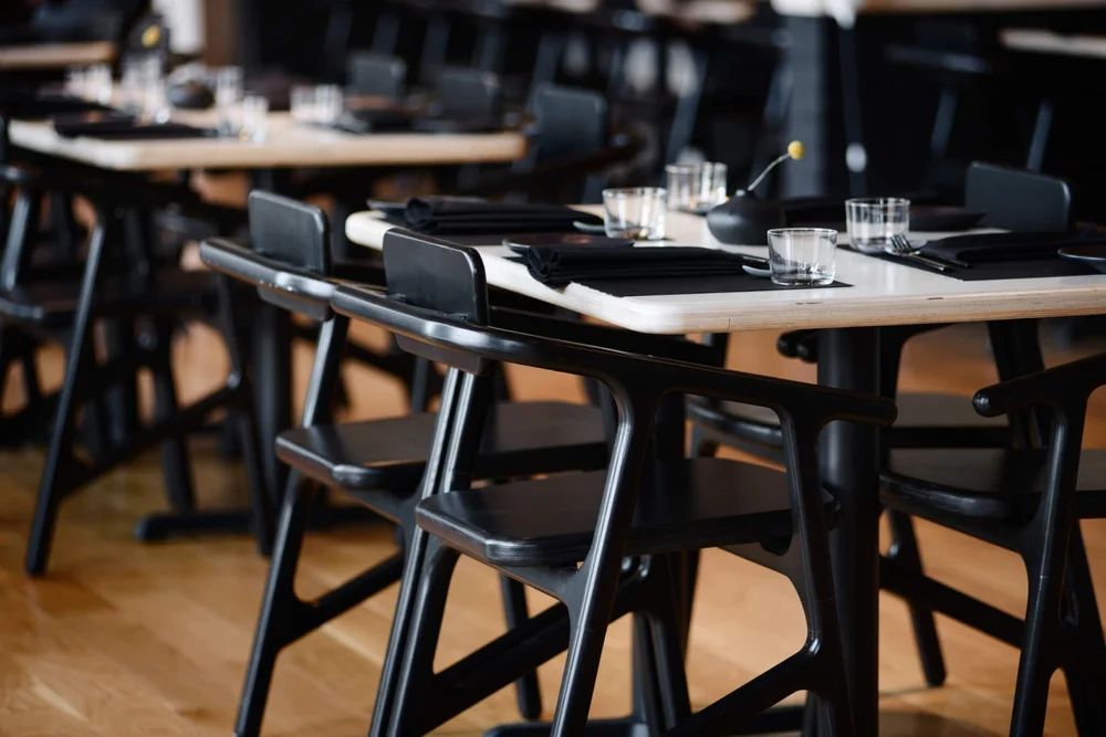Black chairs at tables in a winery