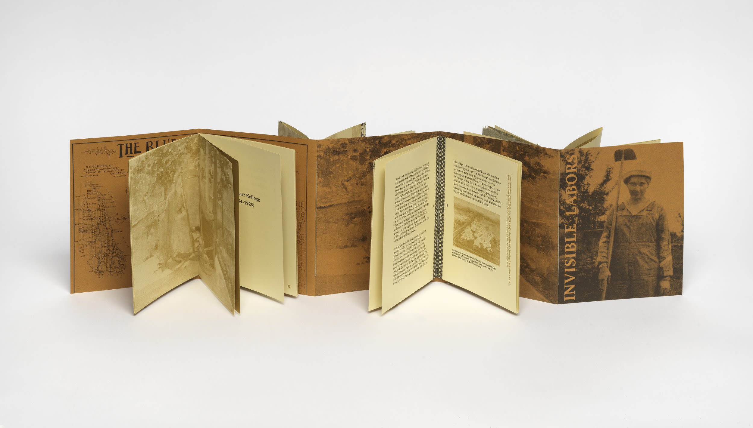 A foldout book display of a text called Invisible Labors
