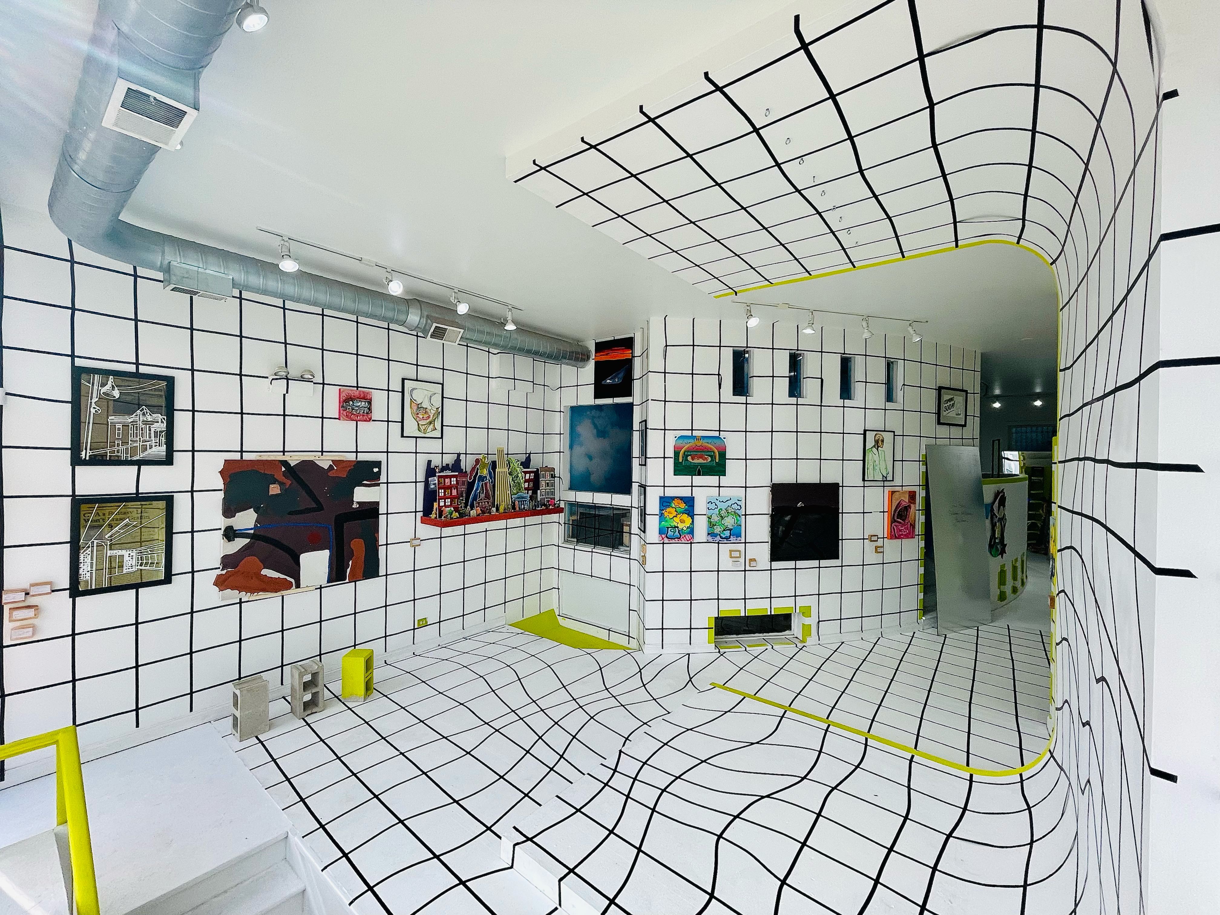 A black and white checkered room with different art pieces on display