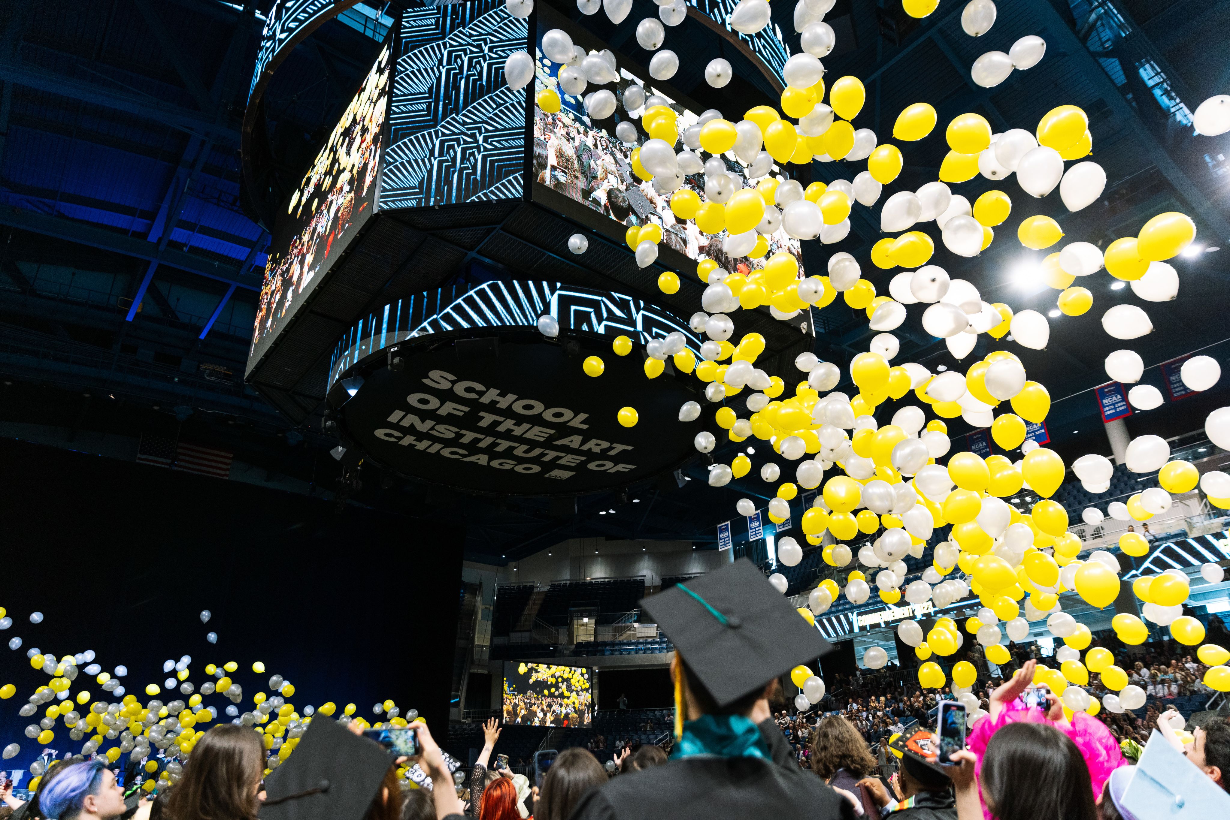 White and yellow balloons drop at Commencement