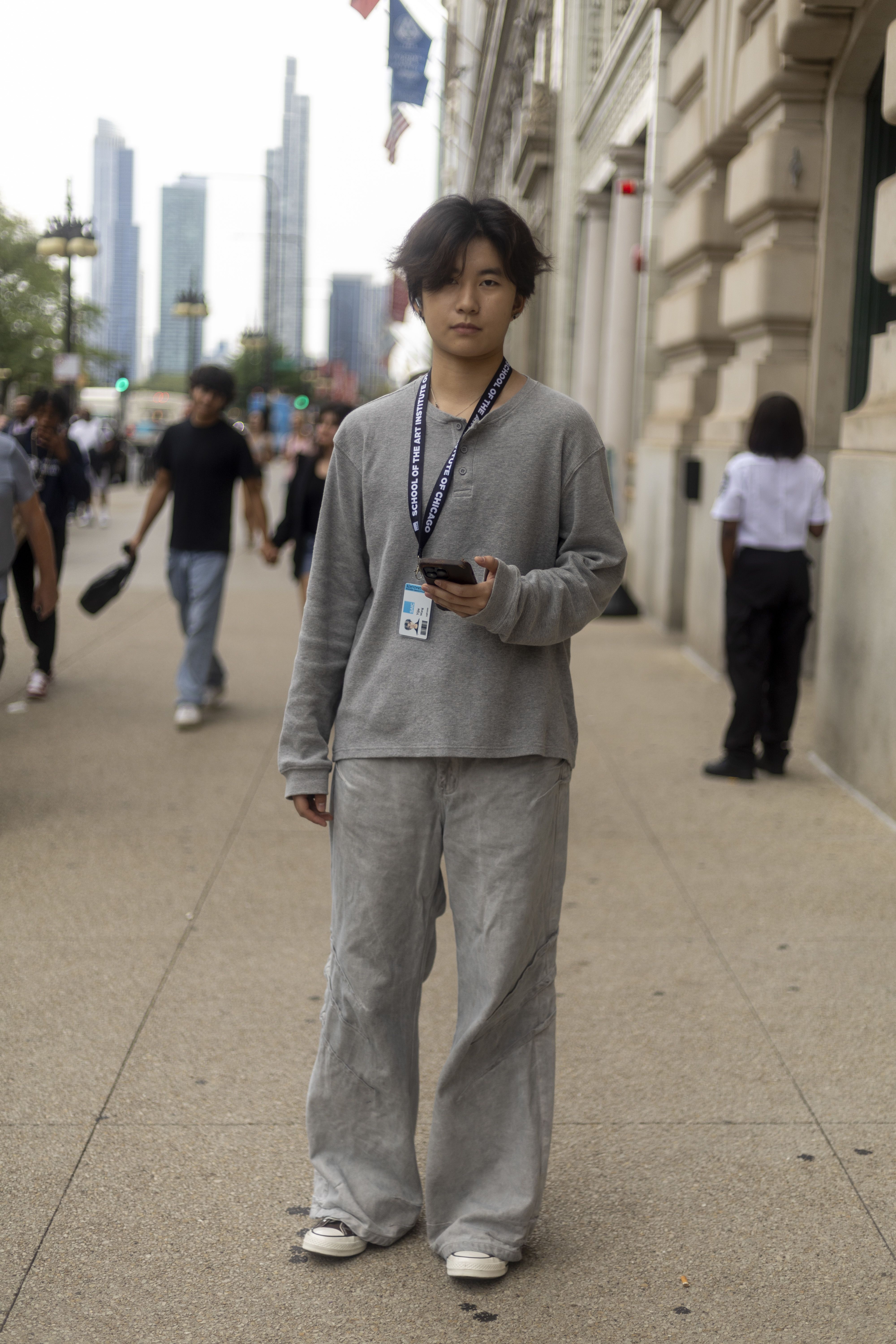A student in a grey outfit