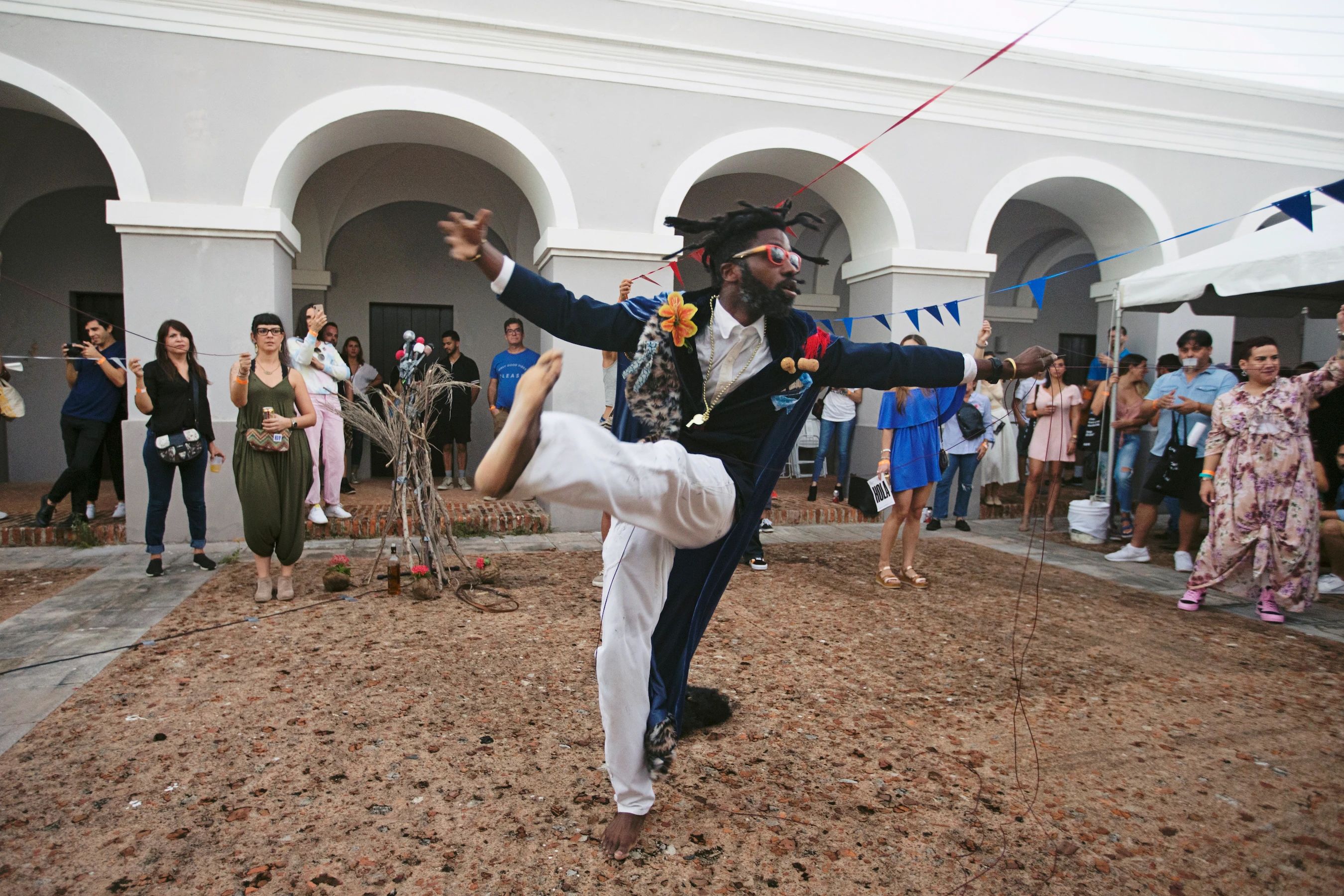 An artist performing on a pit of sand