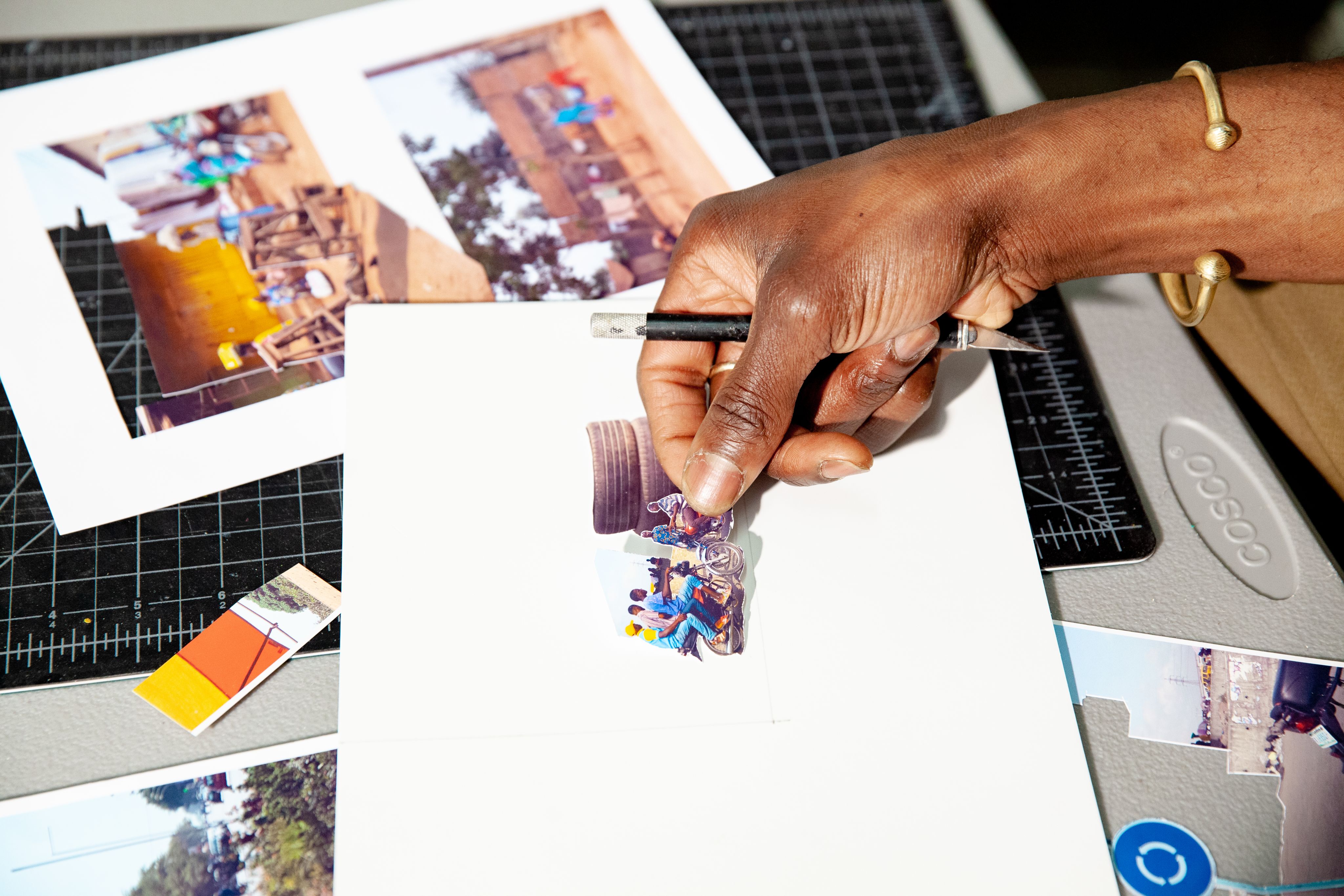 An artist creating a work on a piece of white paper