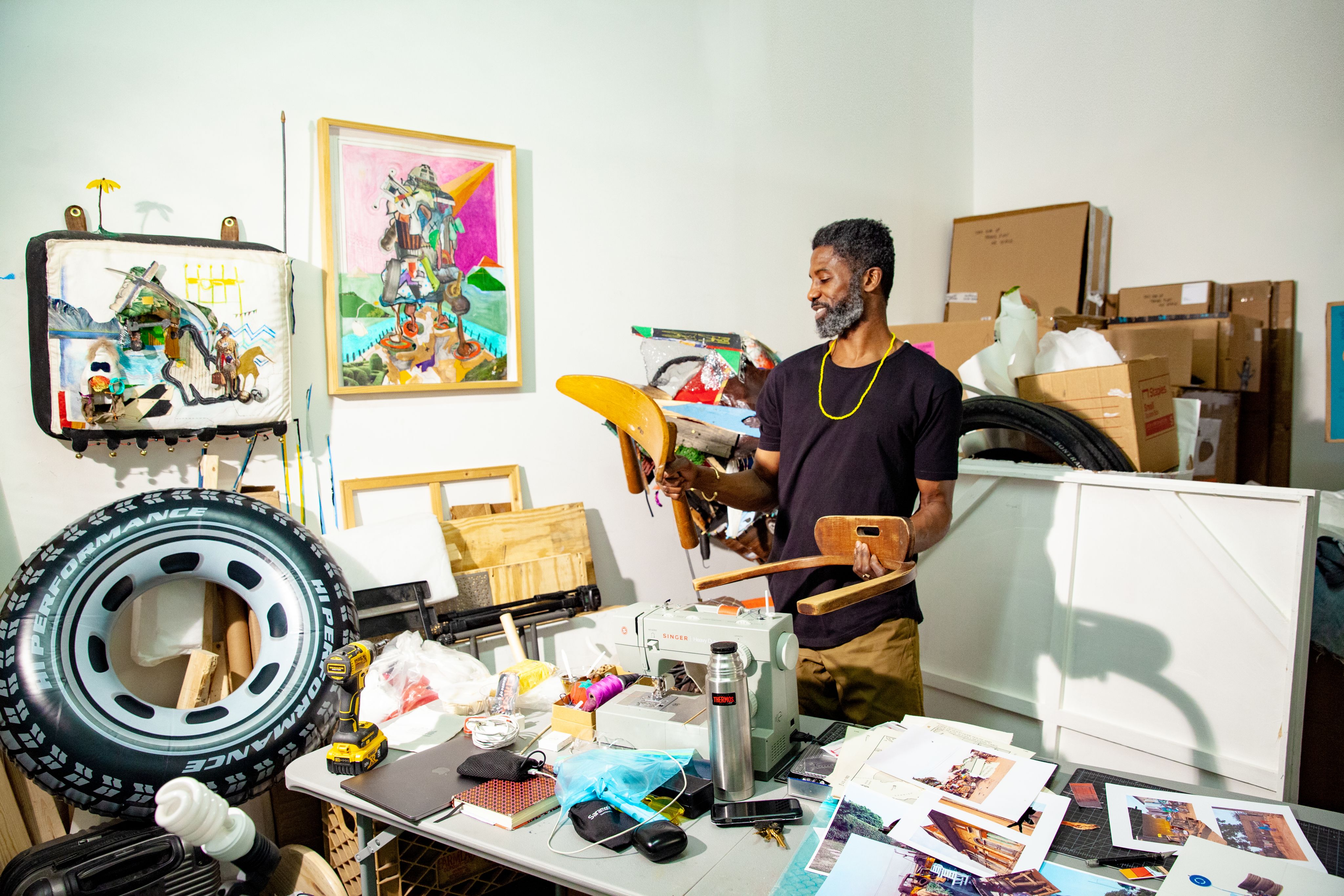 An artist sorts through materials in his studio
