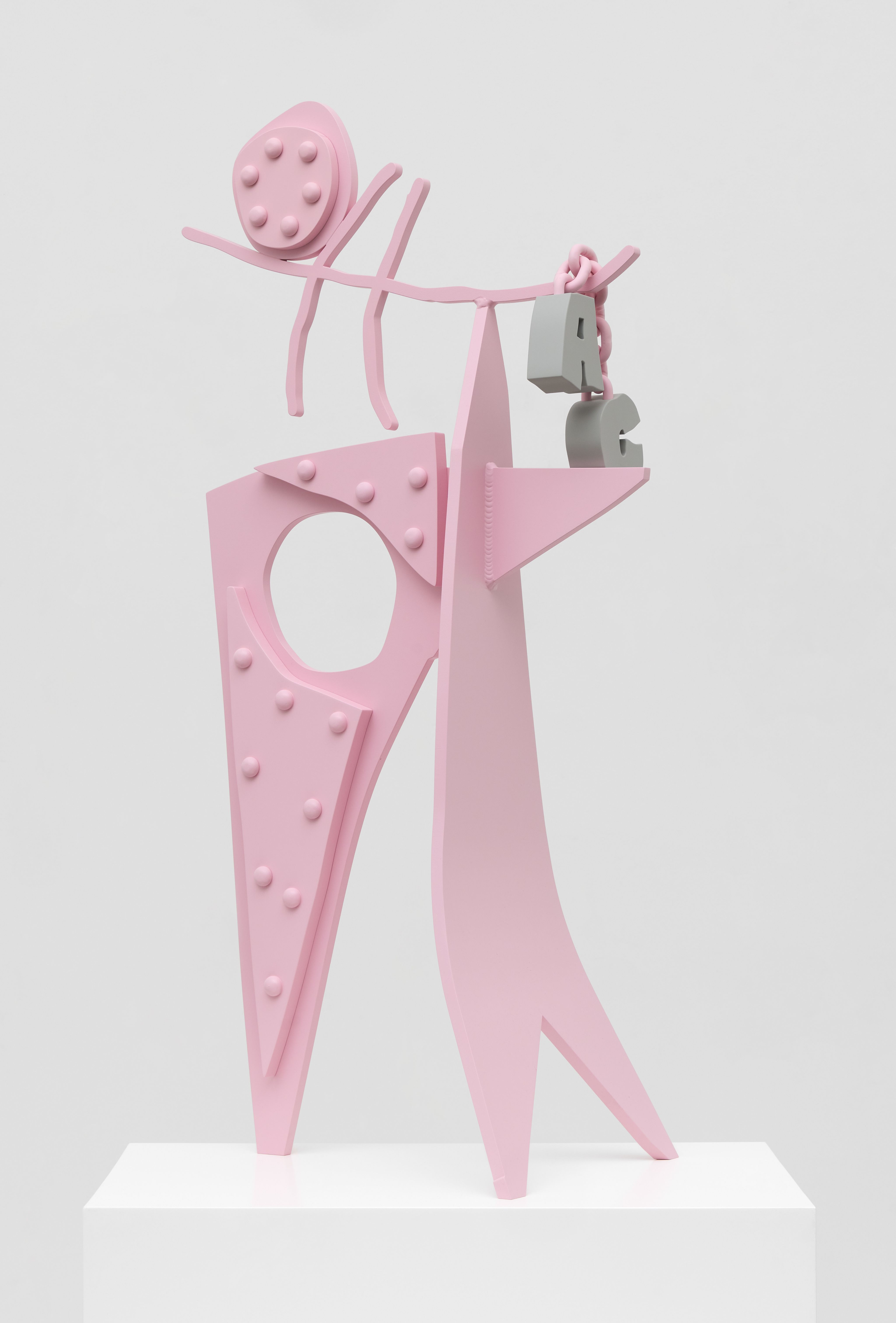A pink sculpture in a gallery