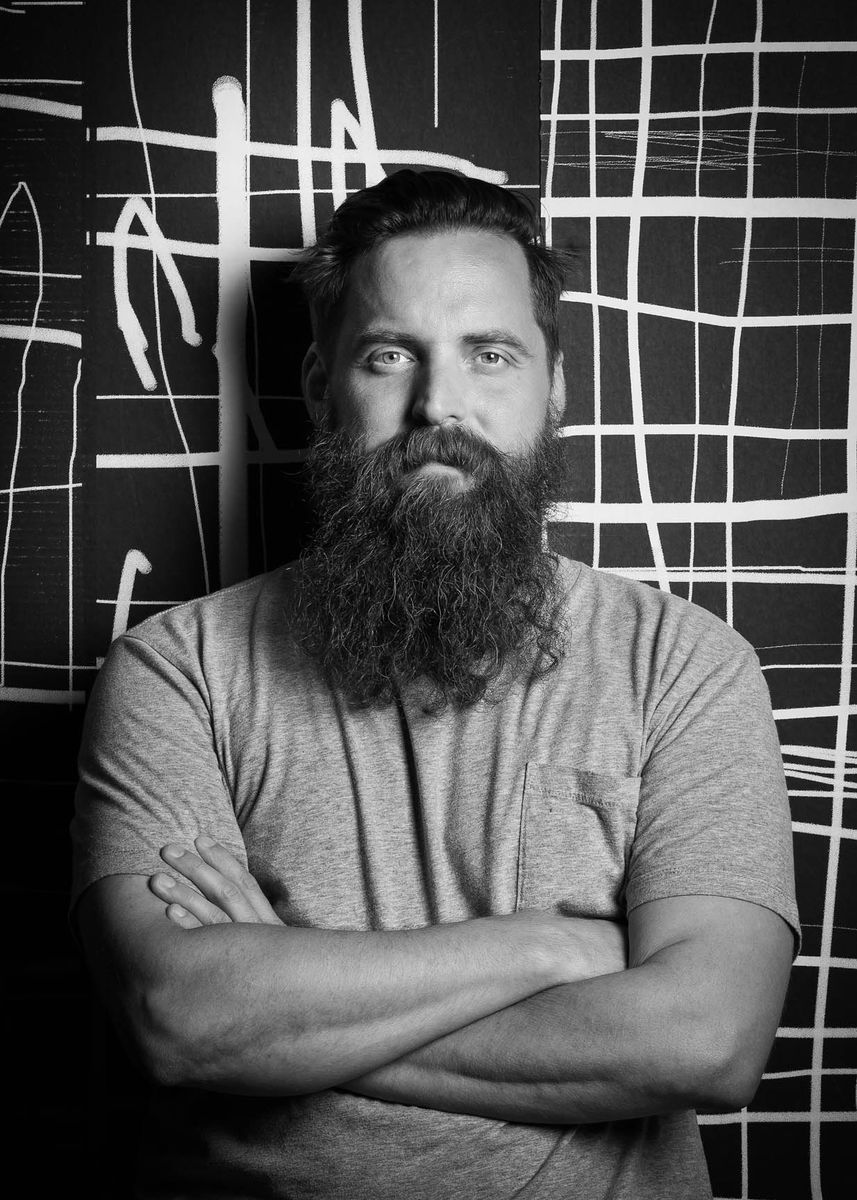 black-and-white photo of a man with a beard