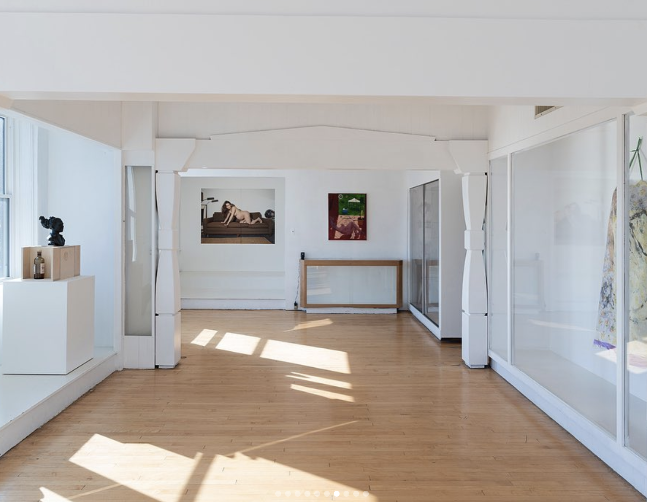 A small, intimate, white-walled gallery space