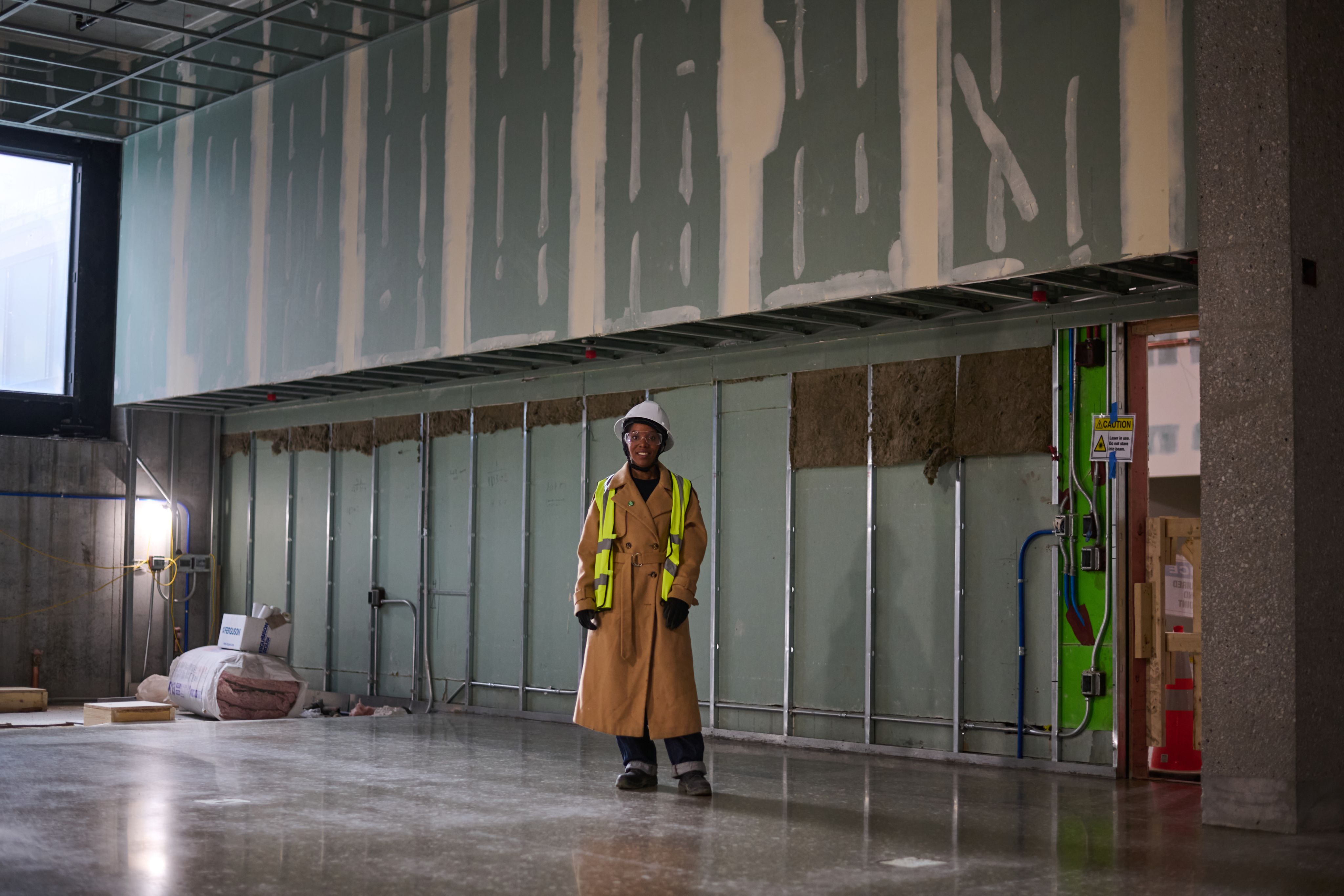 Adams wears a hard hat in a construction zone