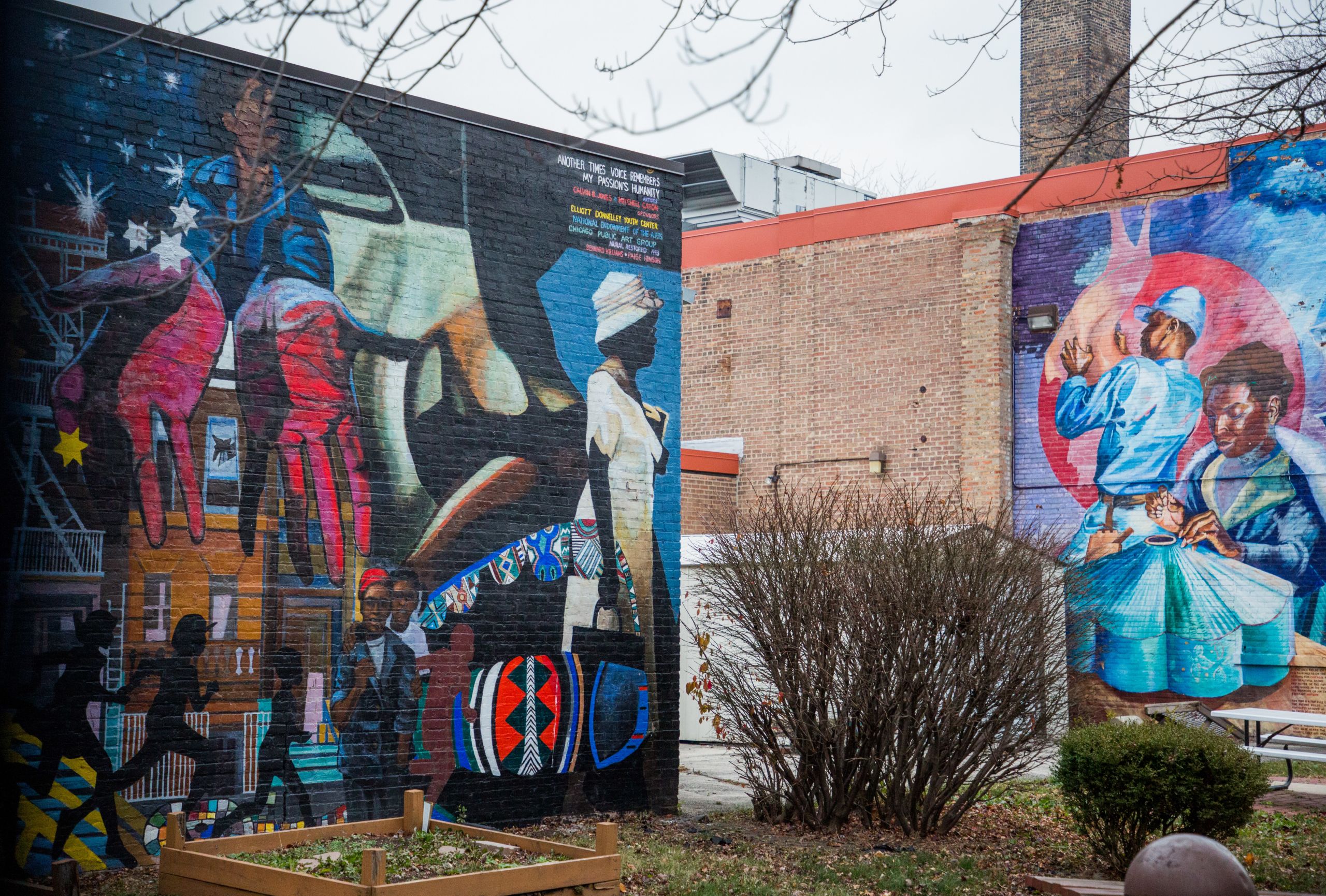 A view of a brightly colored mural on the side of a brick building