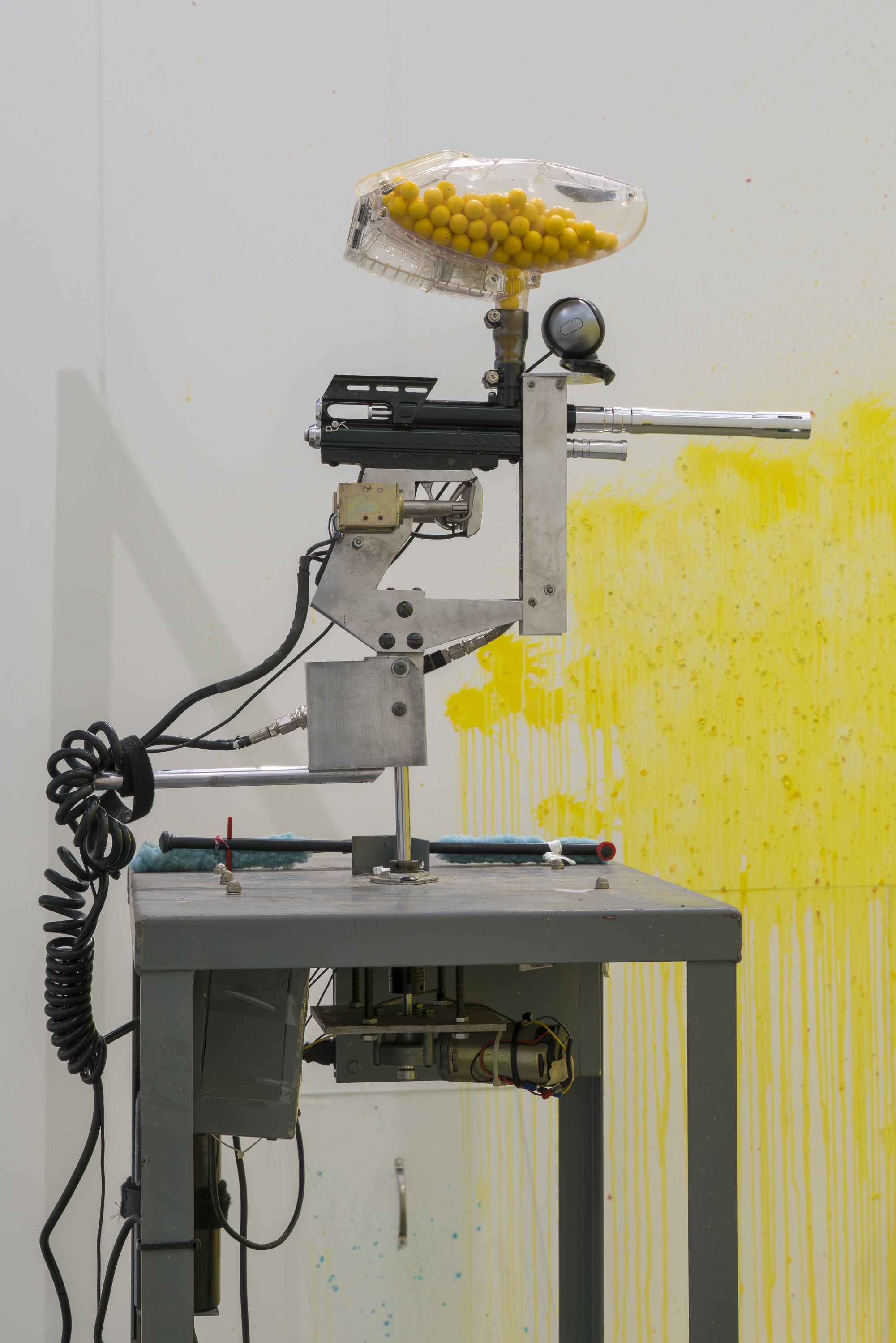 A mounted paint gun with yellow bullets