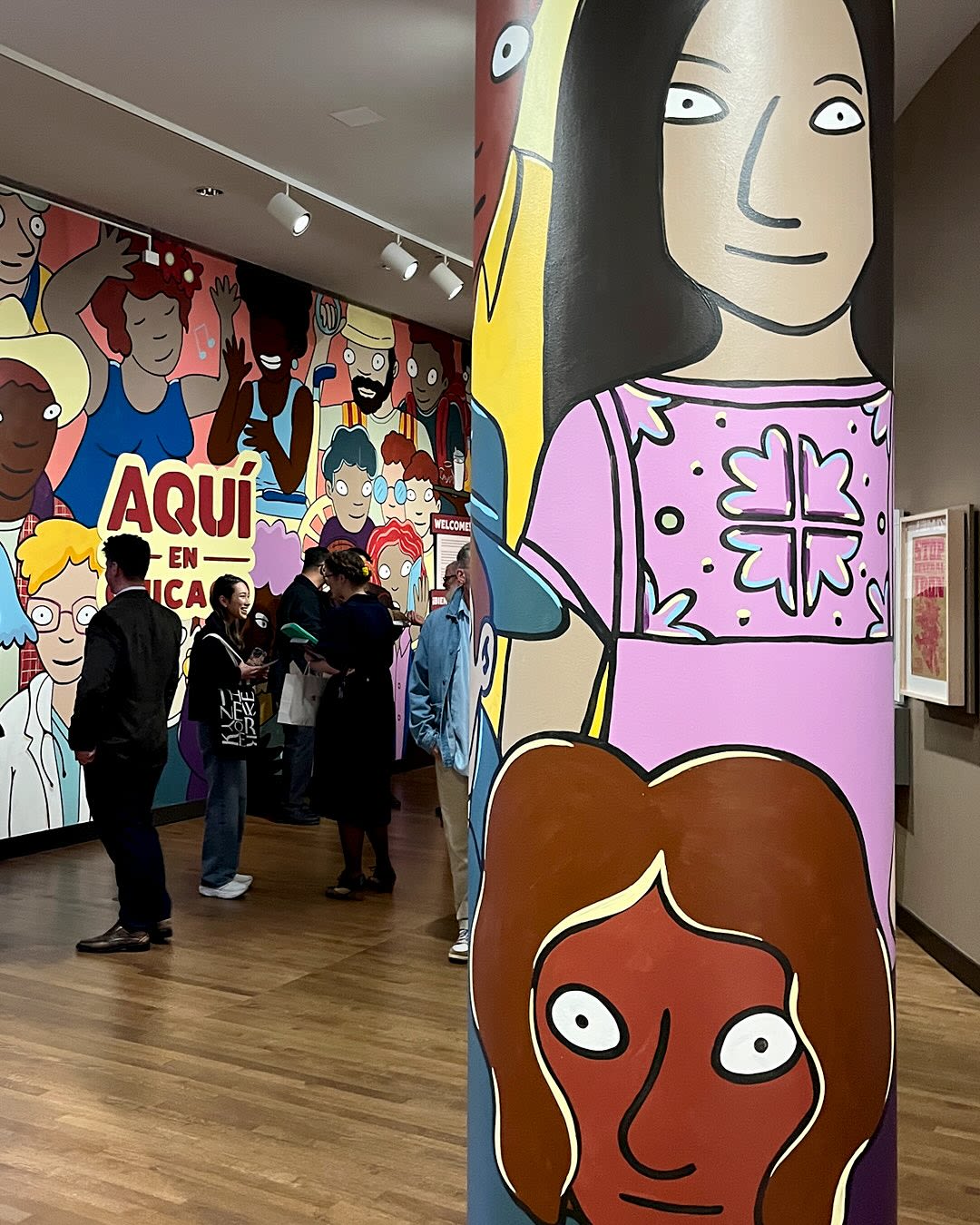 Bright wall murals of people in a museum