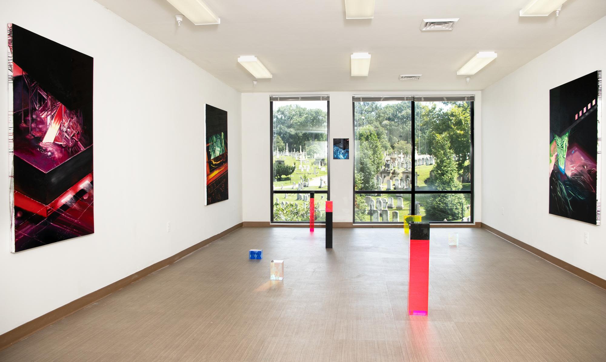 A gallery space with wide windows