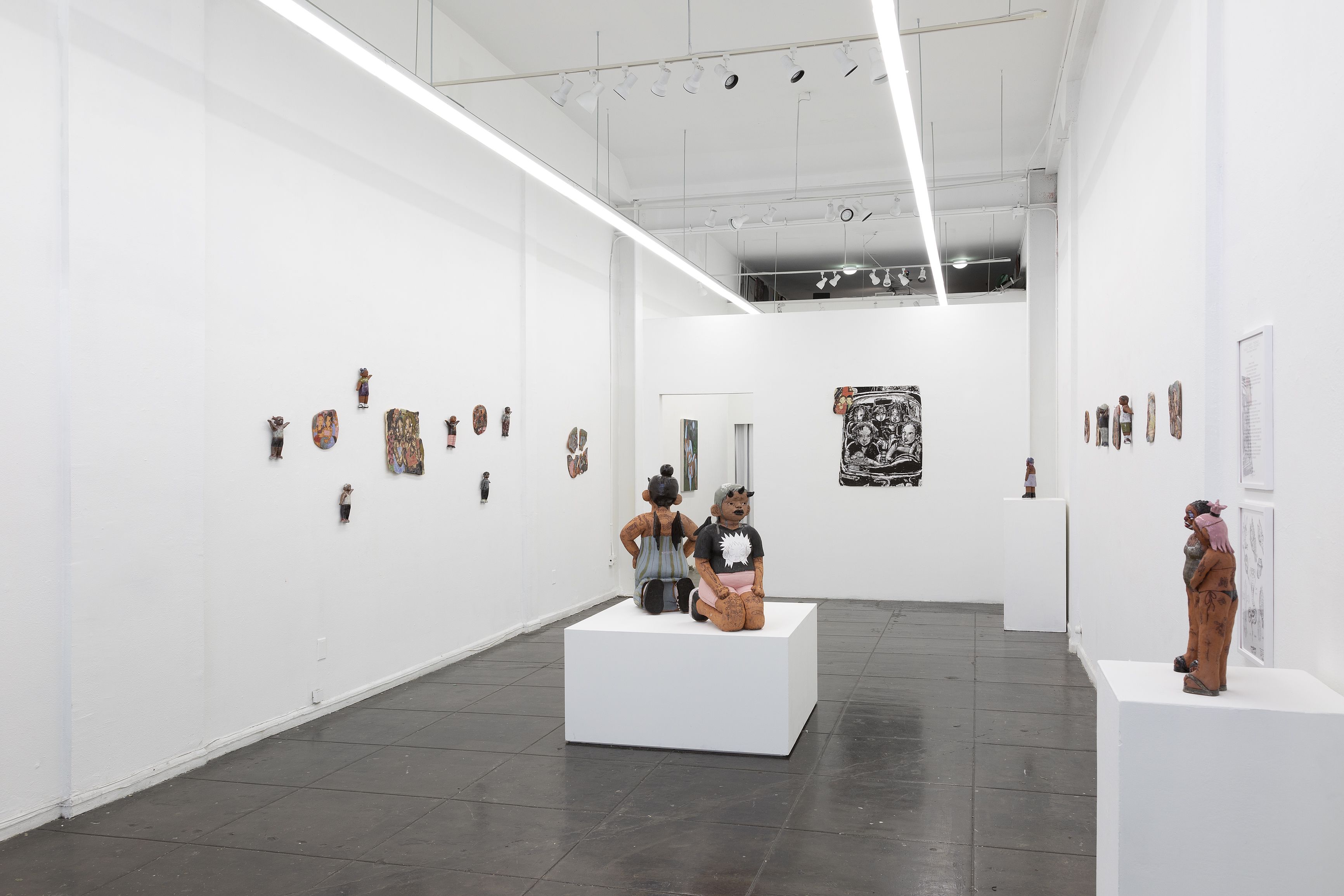 An image of a white gallery with serval ceramic works lining the walls and in the center on a white platform.