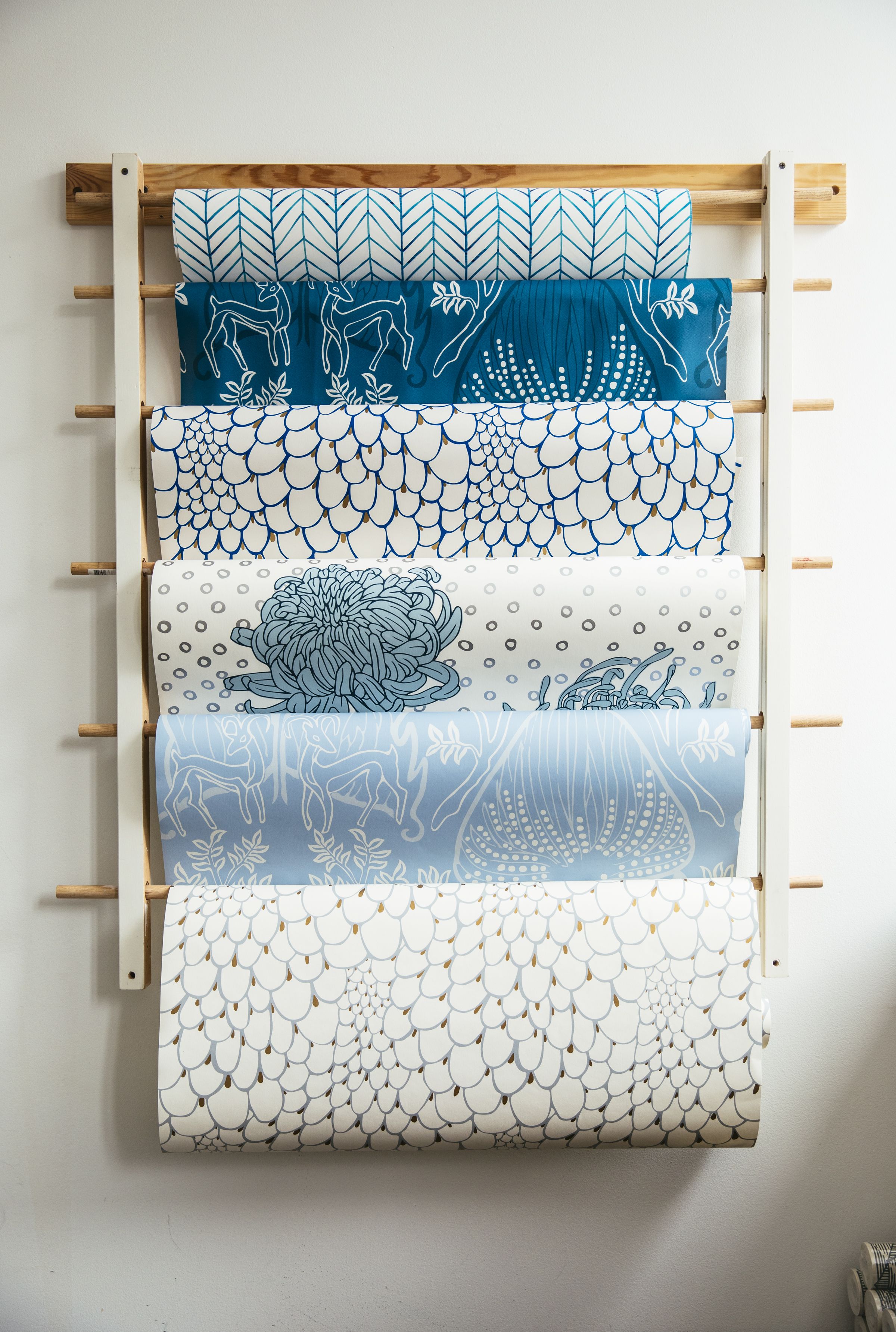 Racks of wallpaper hanging on a wall