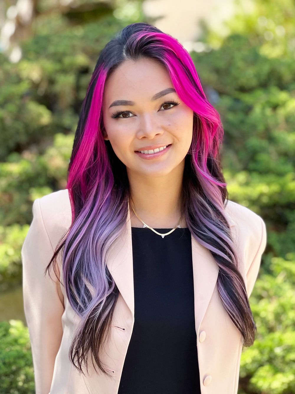 A photo of a woman with dyed-pink hair