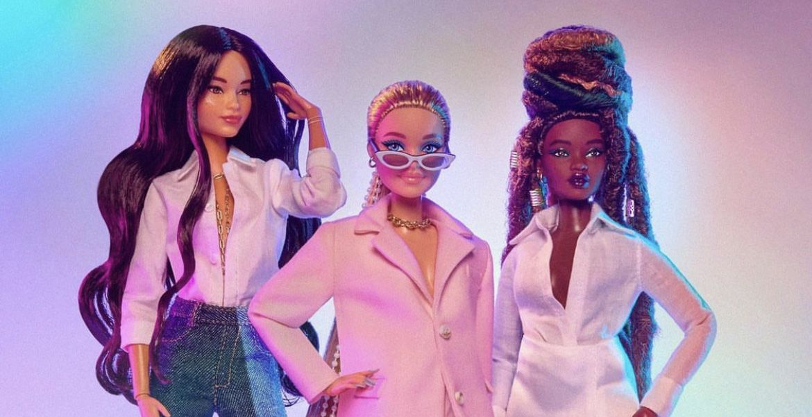 Three Barbies against a pastel background