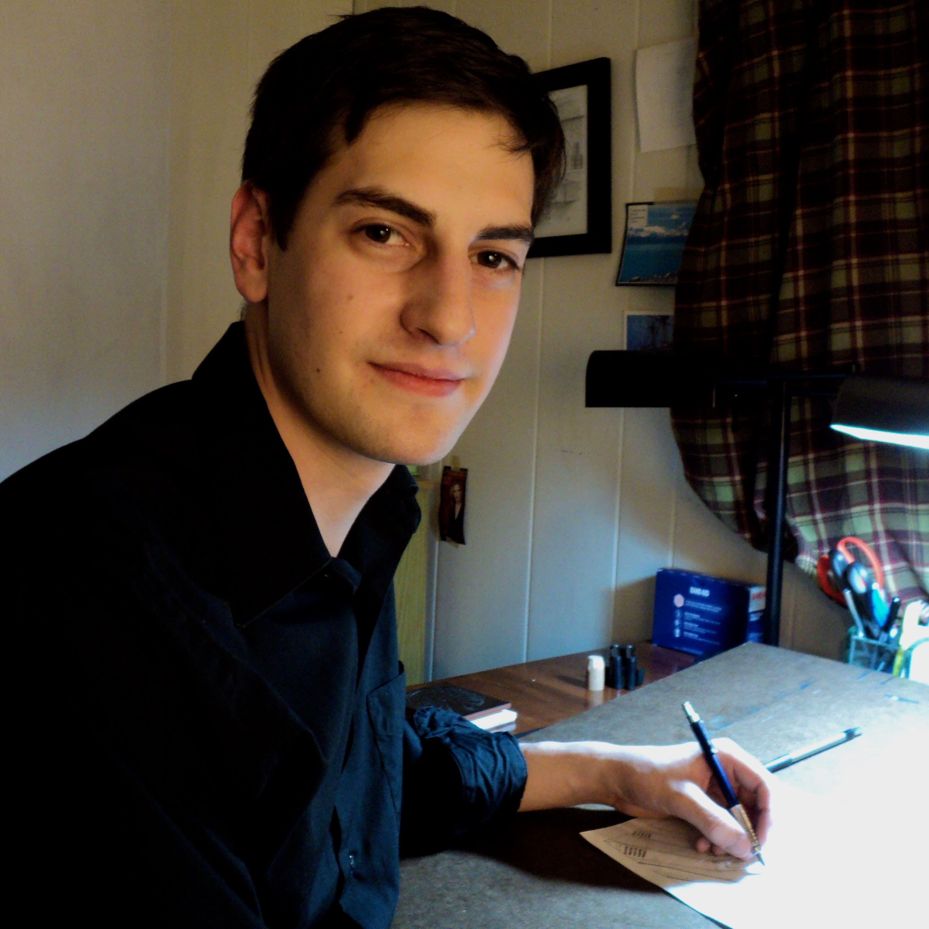 Jedd T. Foulke sits at a desk and draws