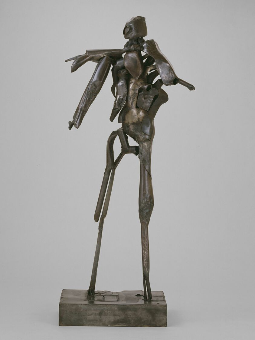 An image of steel sculpture "Hero Construction." The sculpture resembles a person standing upright.