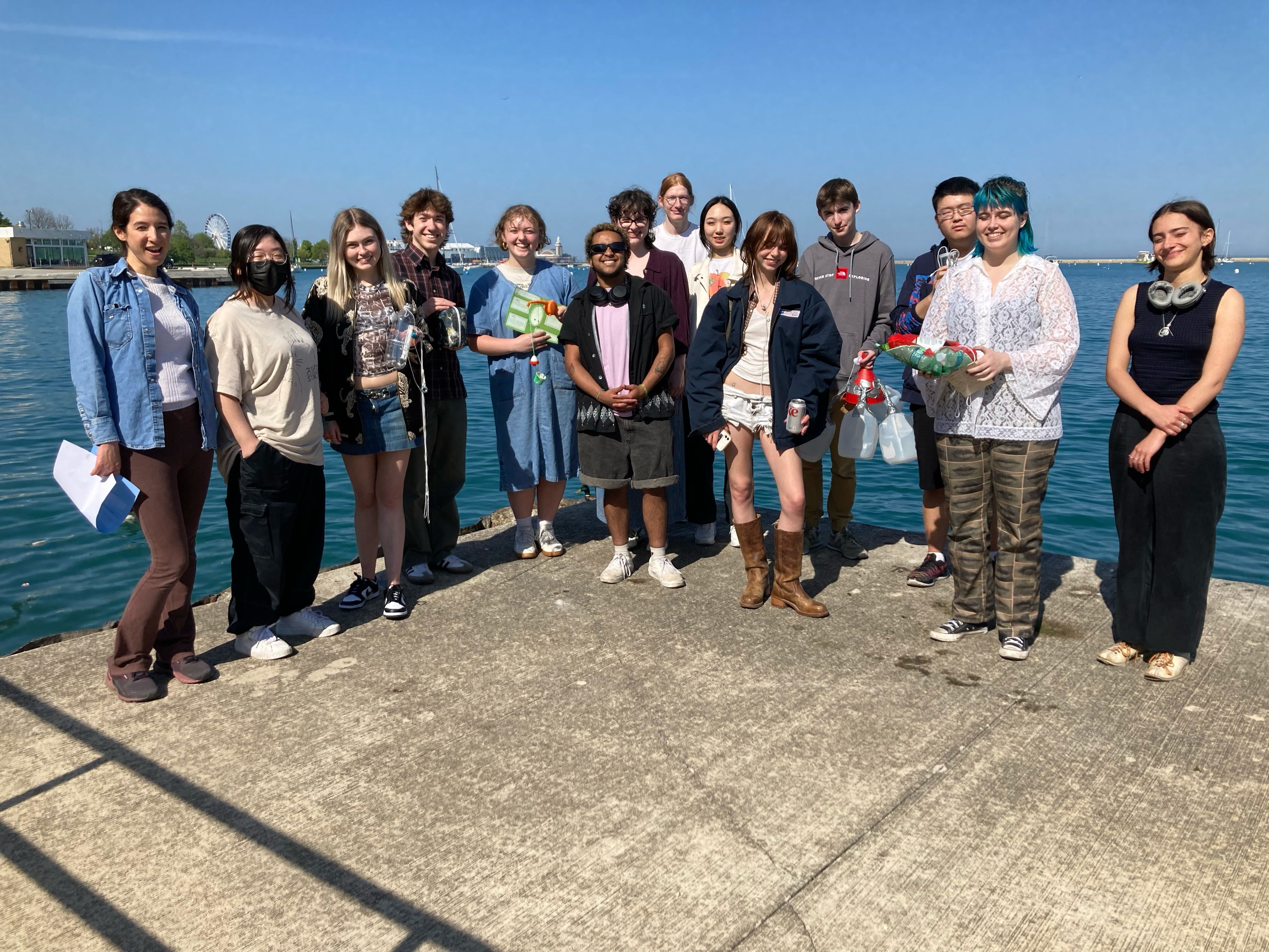 A group of students stand by Lake Michigan