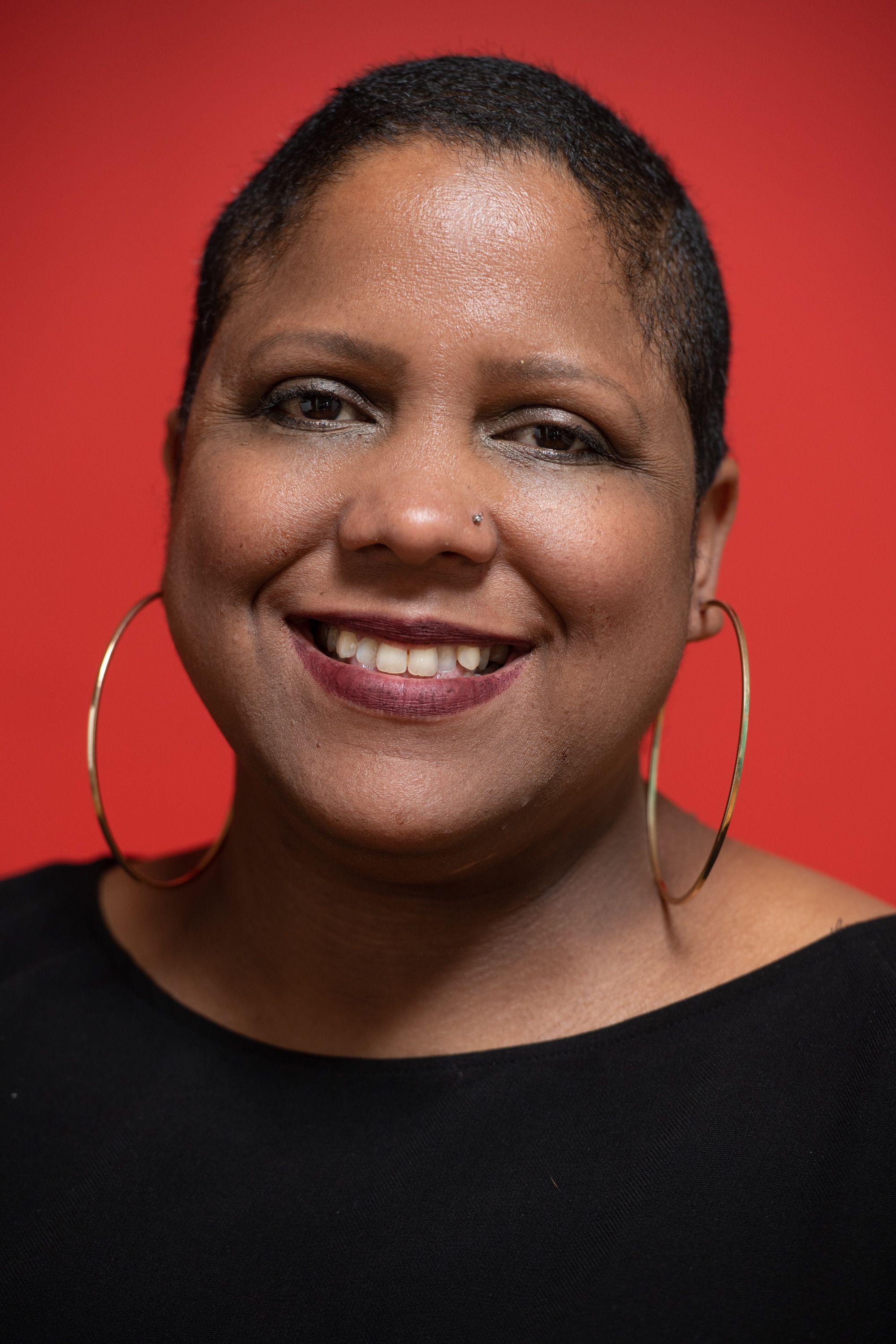 Image of Brenda Torres-Figueroa against a red background.