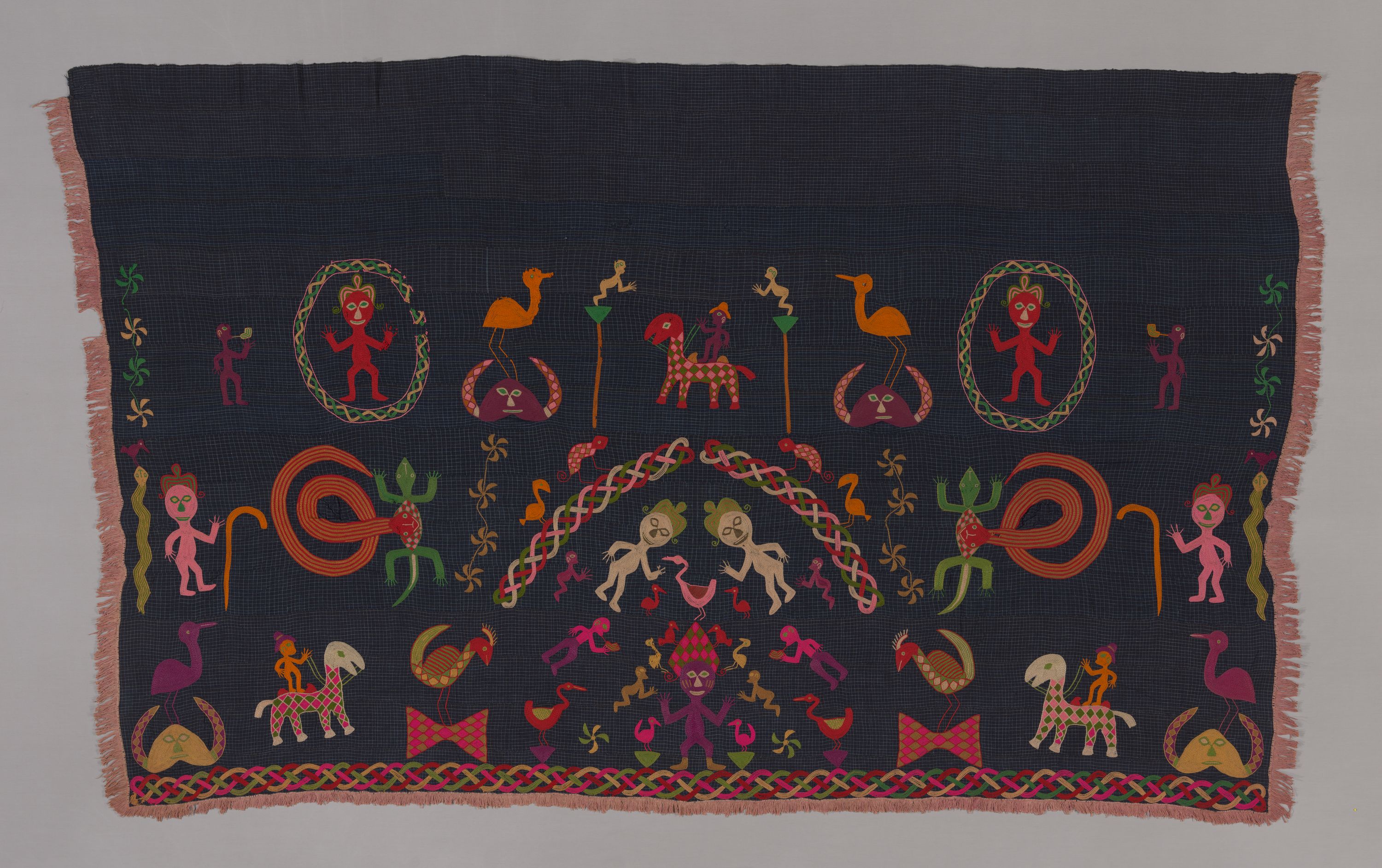 A textile piece featuring figures, animals, plants.