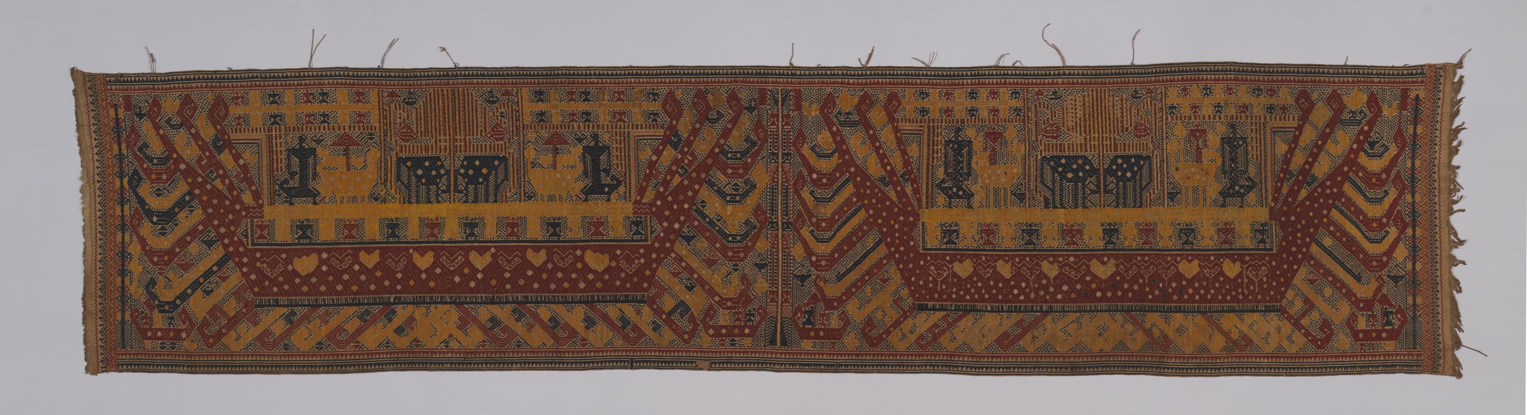 A ceremonial hanging featuring geometric shapes in primary colors.